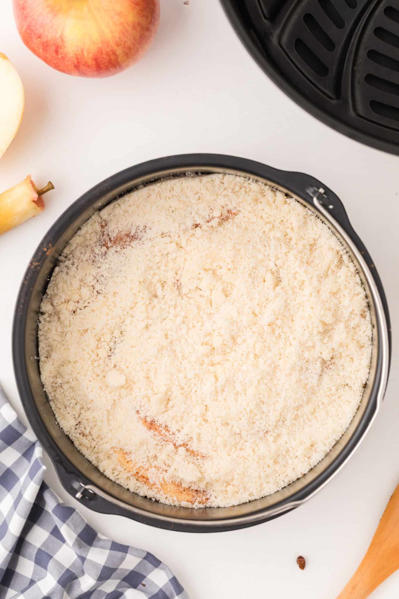apple crisp in pan with topping.