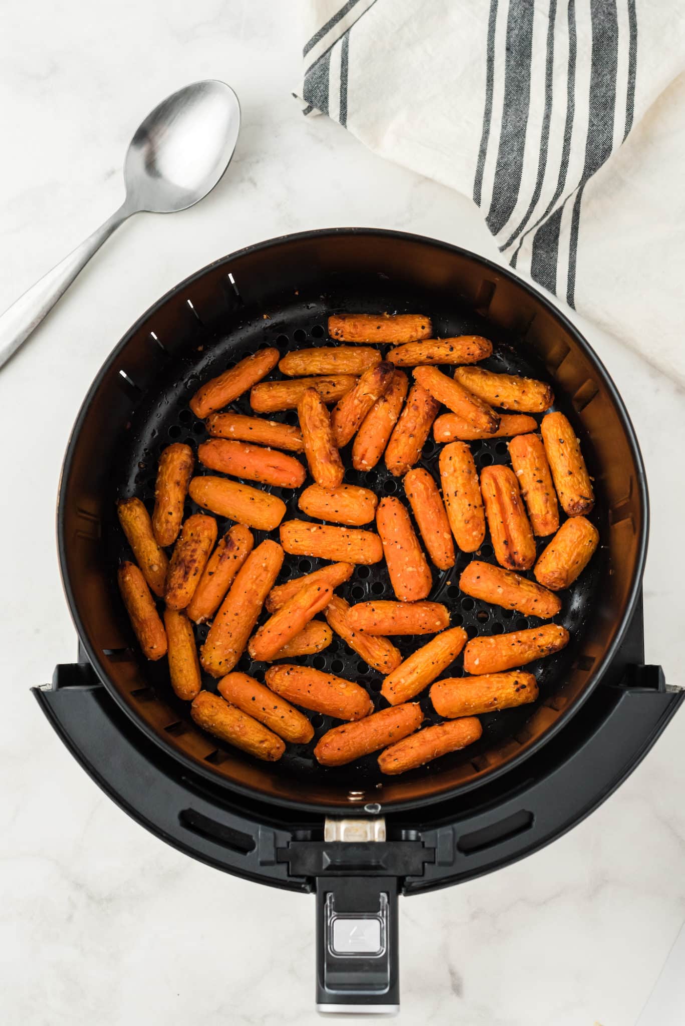 cooked baby carrots in air fryer basket