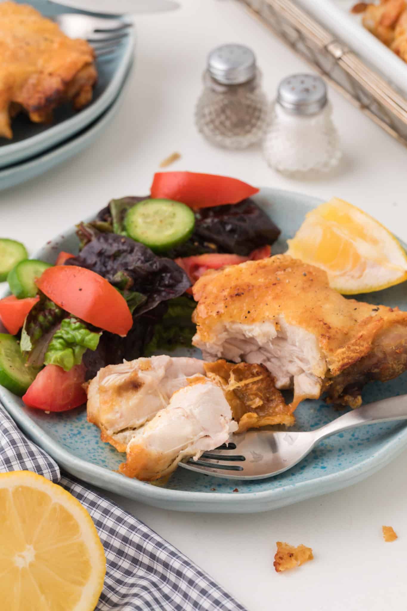 air fried bone-in chicken thighs served on a plate.