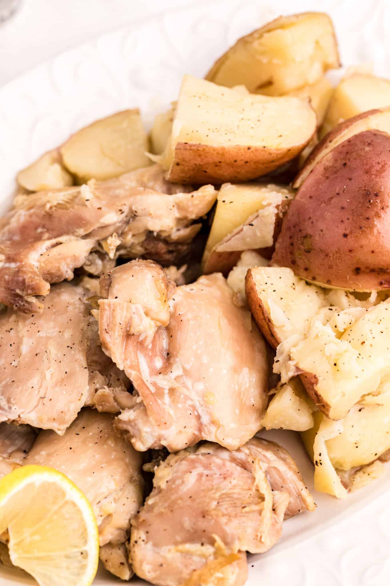 cooked chicken and potatoes in a serving dish