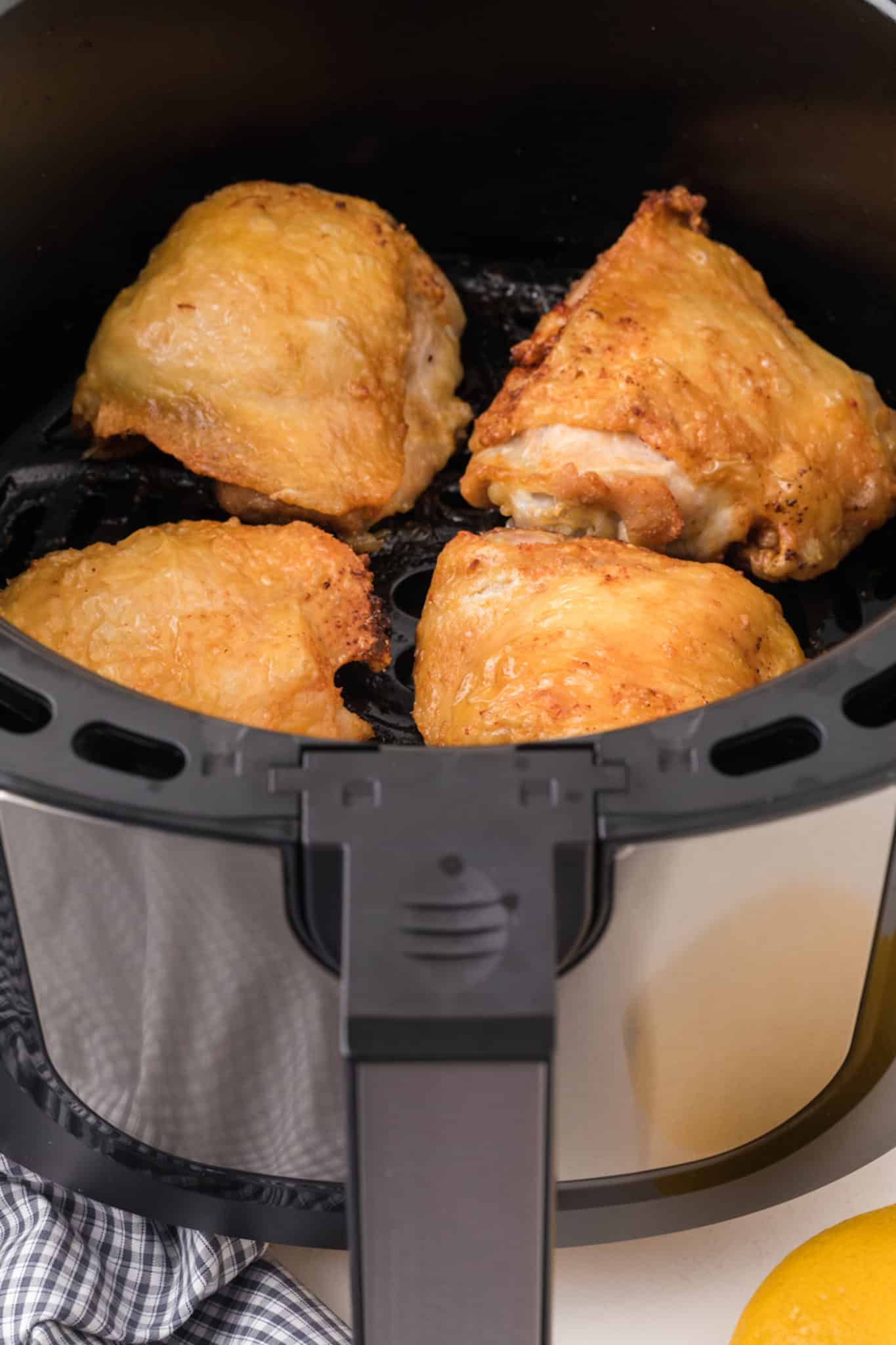 cooked chicken thighs in air fryer basket