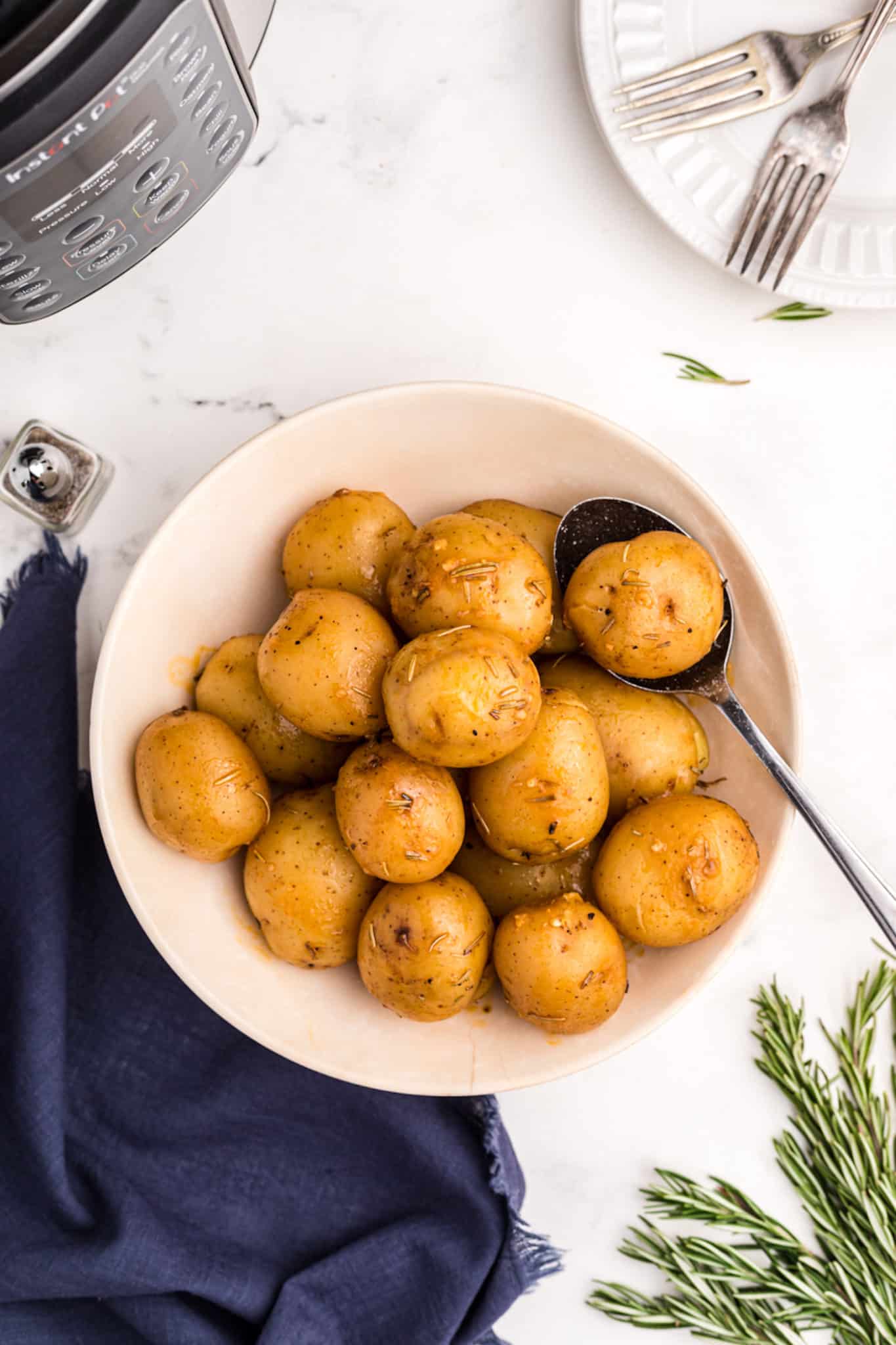 bowl of cooked potatoes with serving spoon