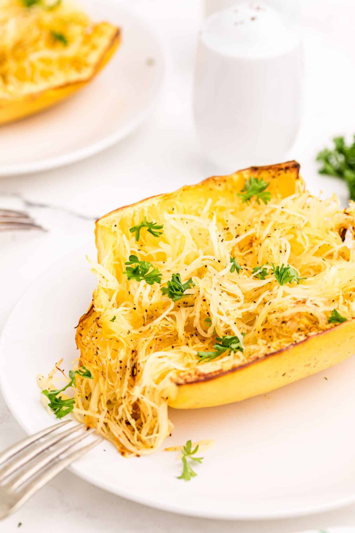 cooked half of a crockpot spaghetti squash on a plate.