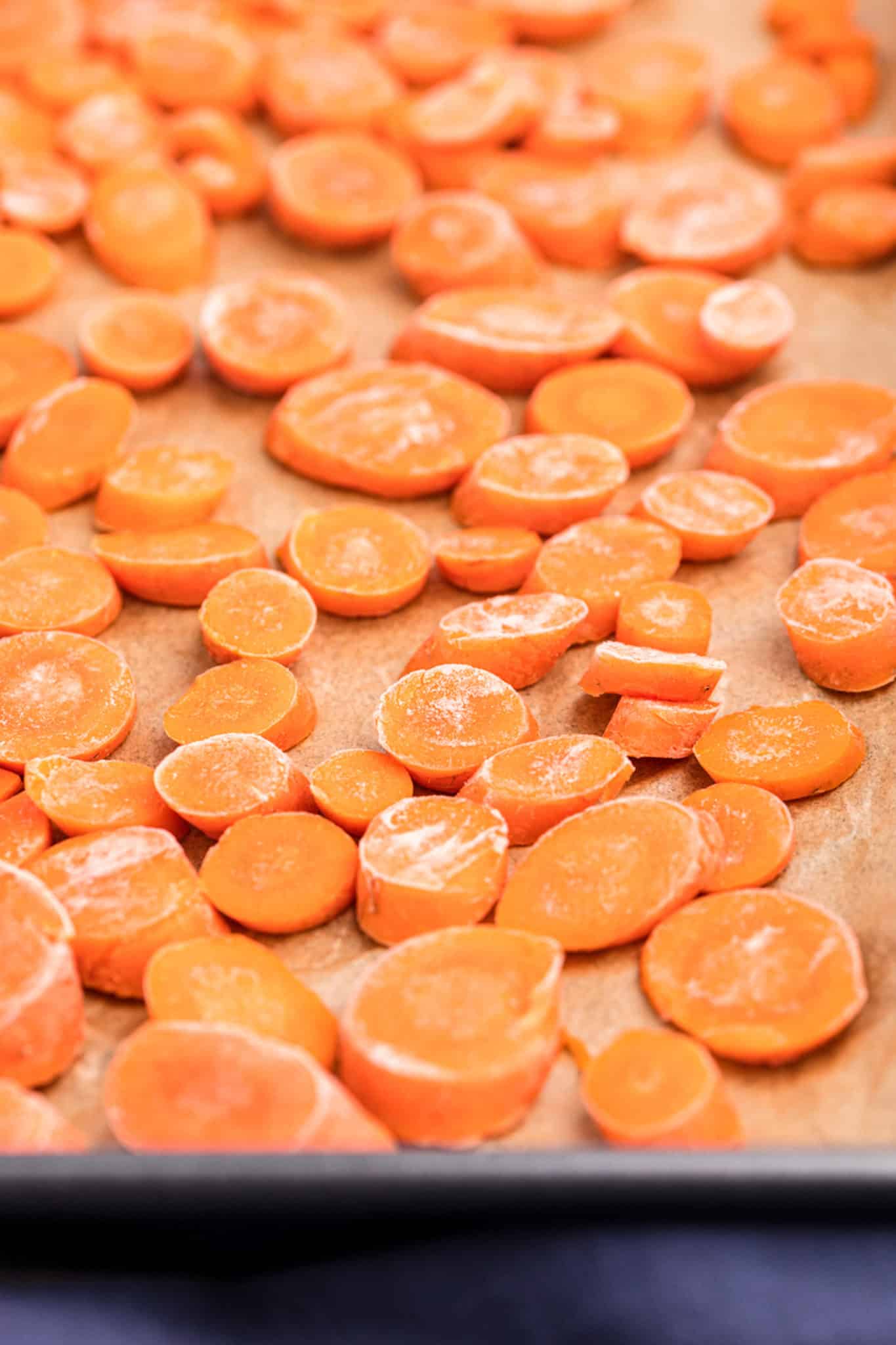 frozen carrot slices on baking sheet