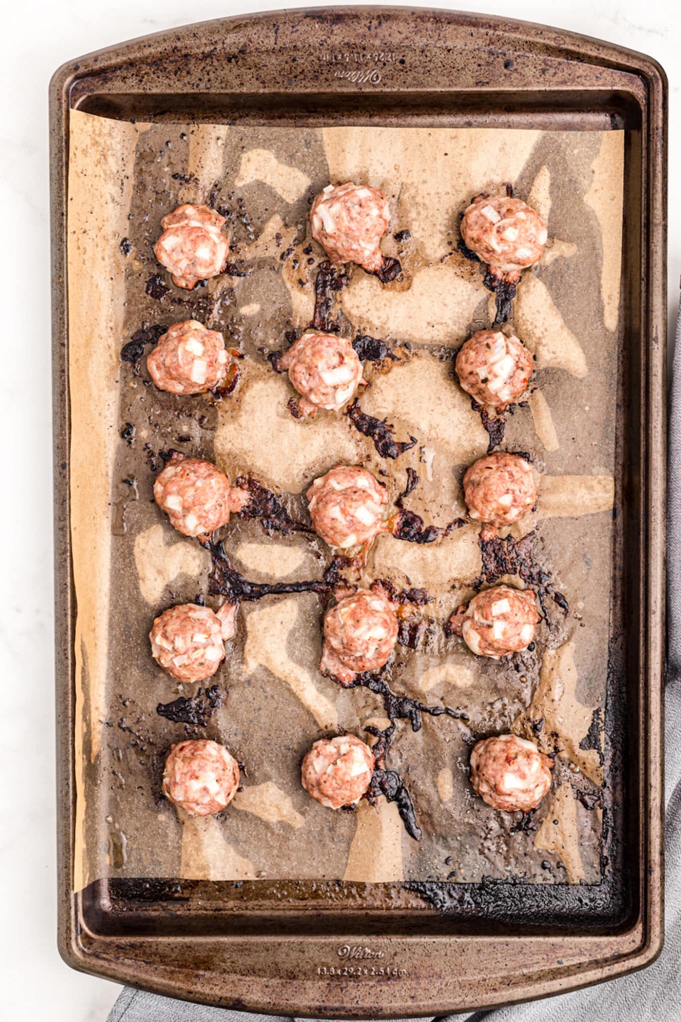 baked pork meatballs on baking sheet