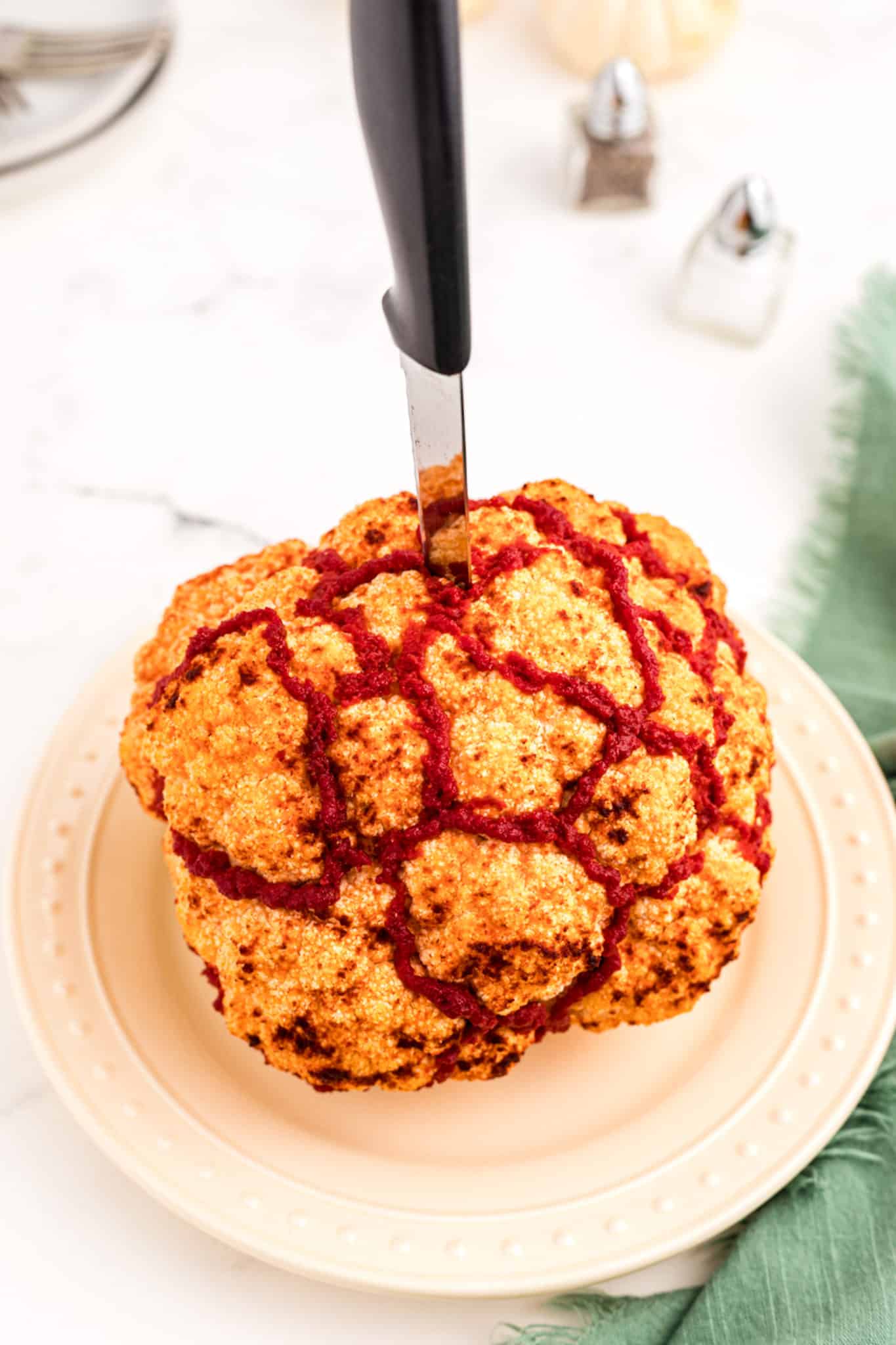 roasted cauliflower brain with knife in it