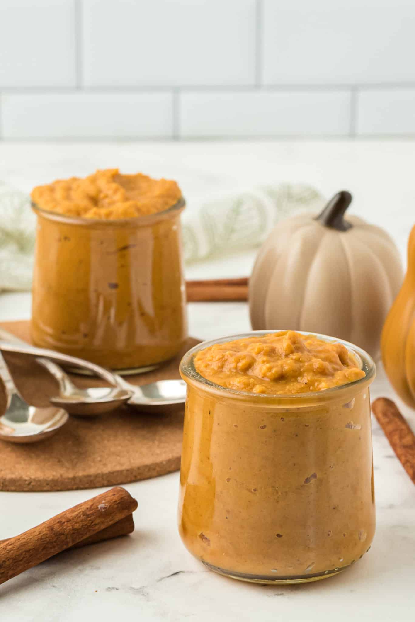 pumpkin pudding in jars on a tabletop.