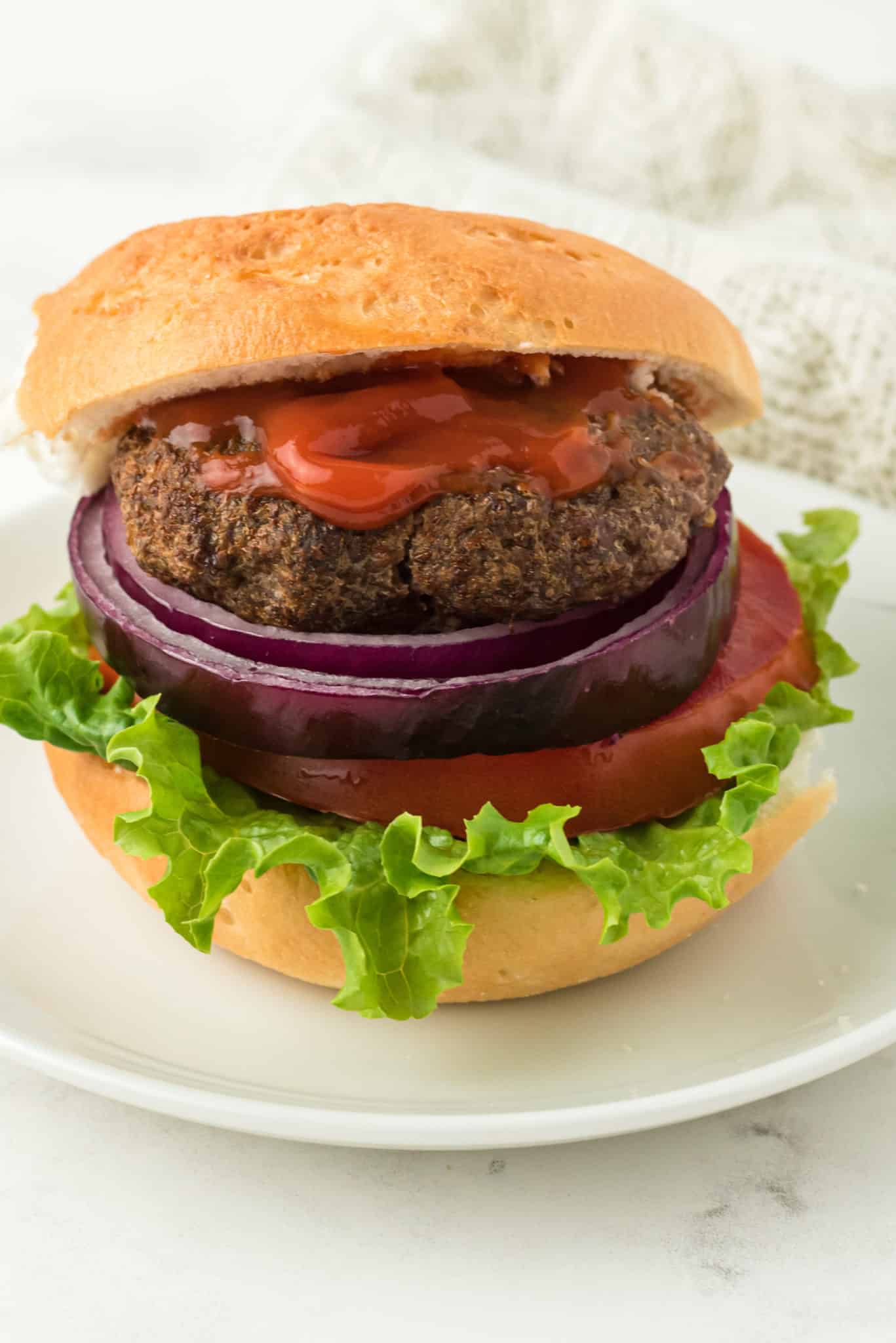 air fried hamburger served with bun and toppings.