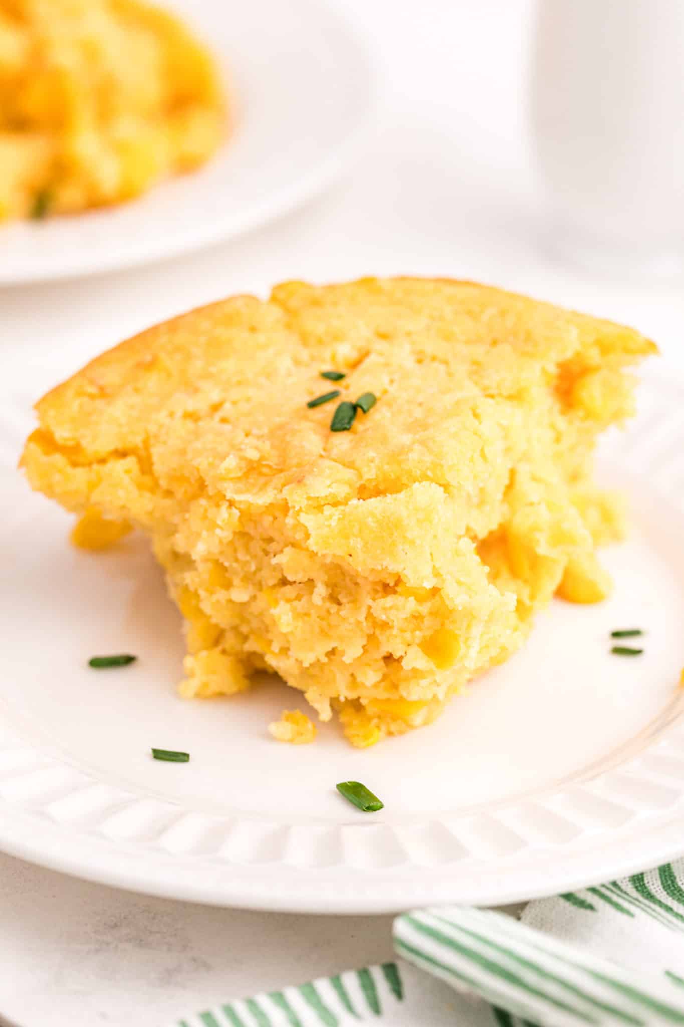 a slice of corn casserole on plate made without milk or butter.