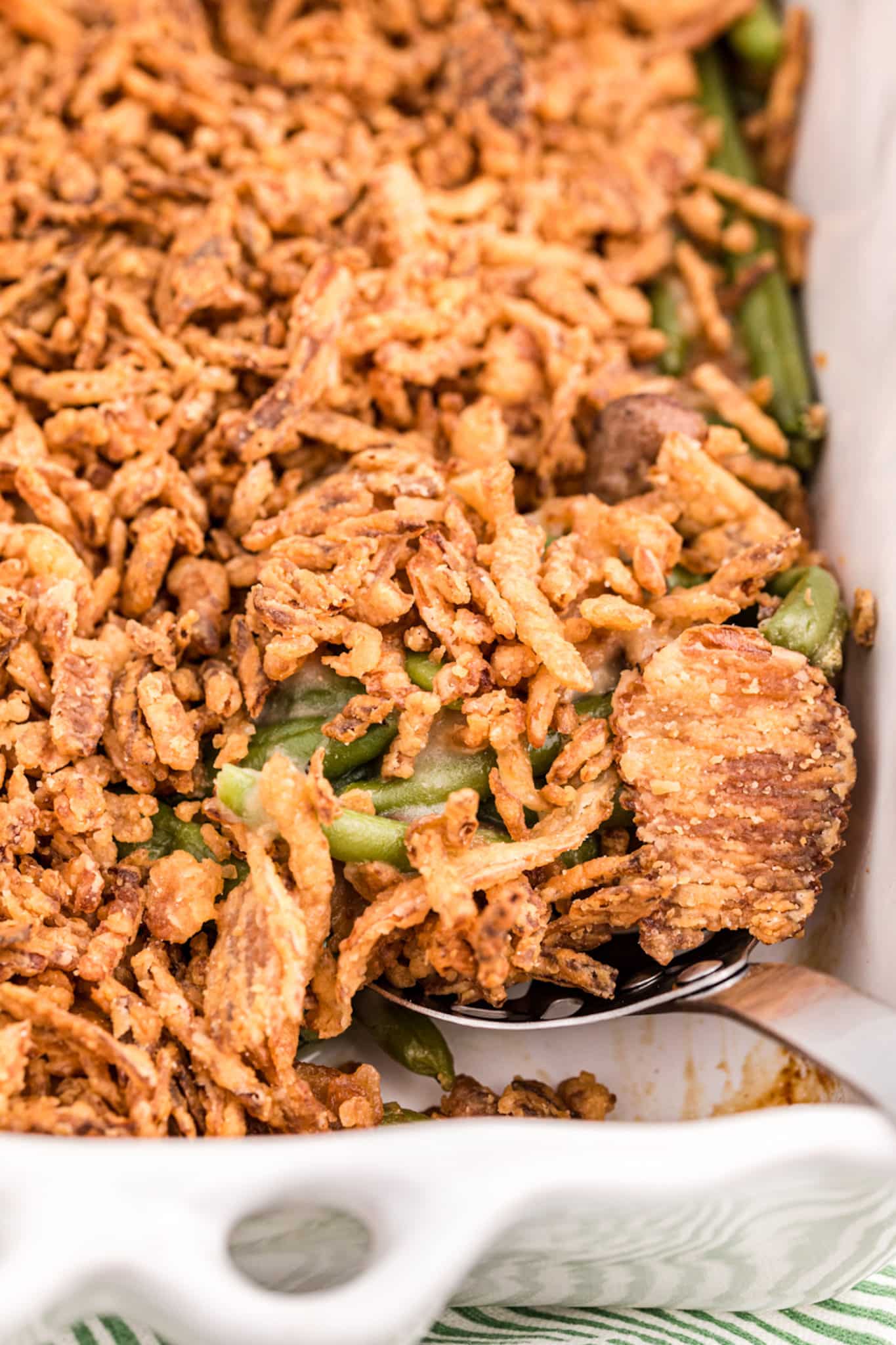 green bean casserole with serving spoon.