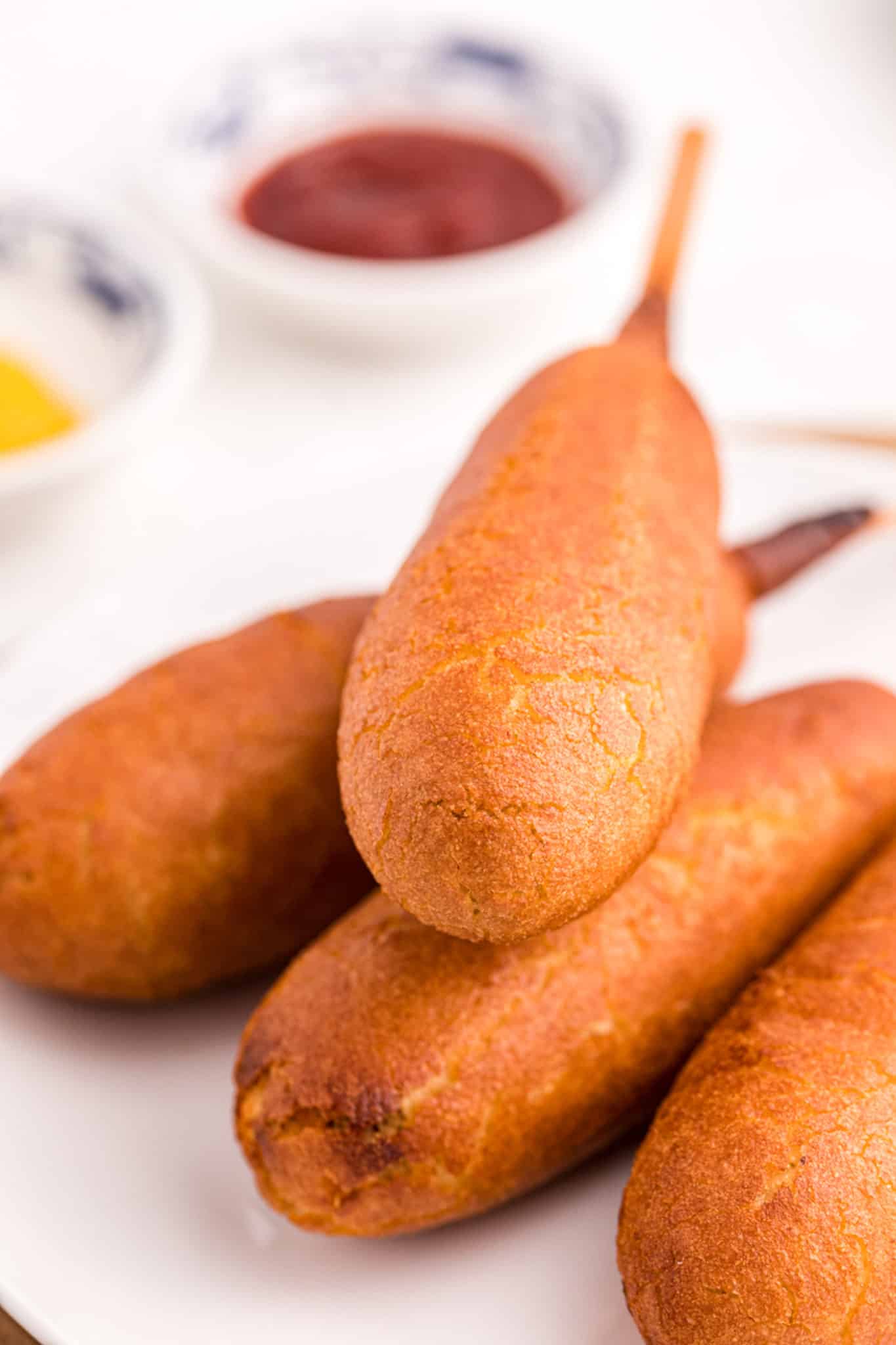corn dogs on a plate.