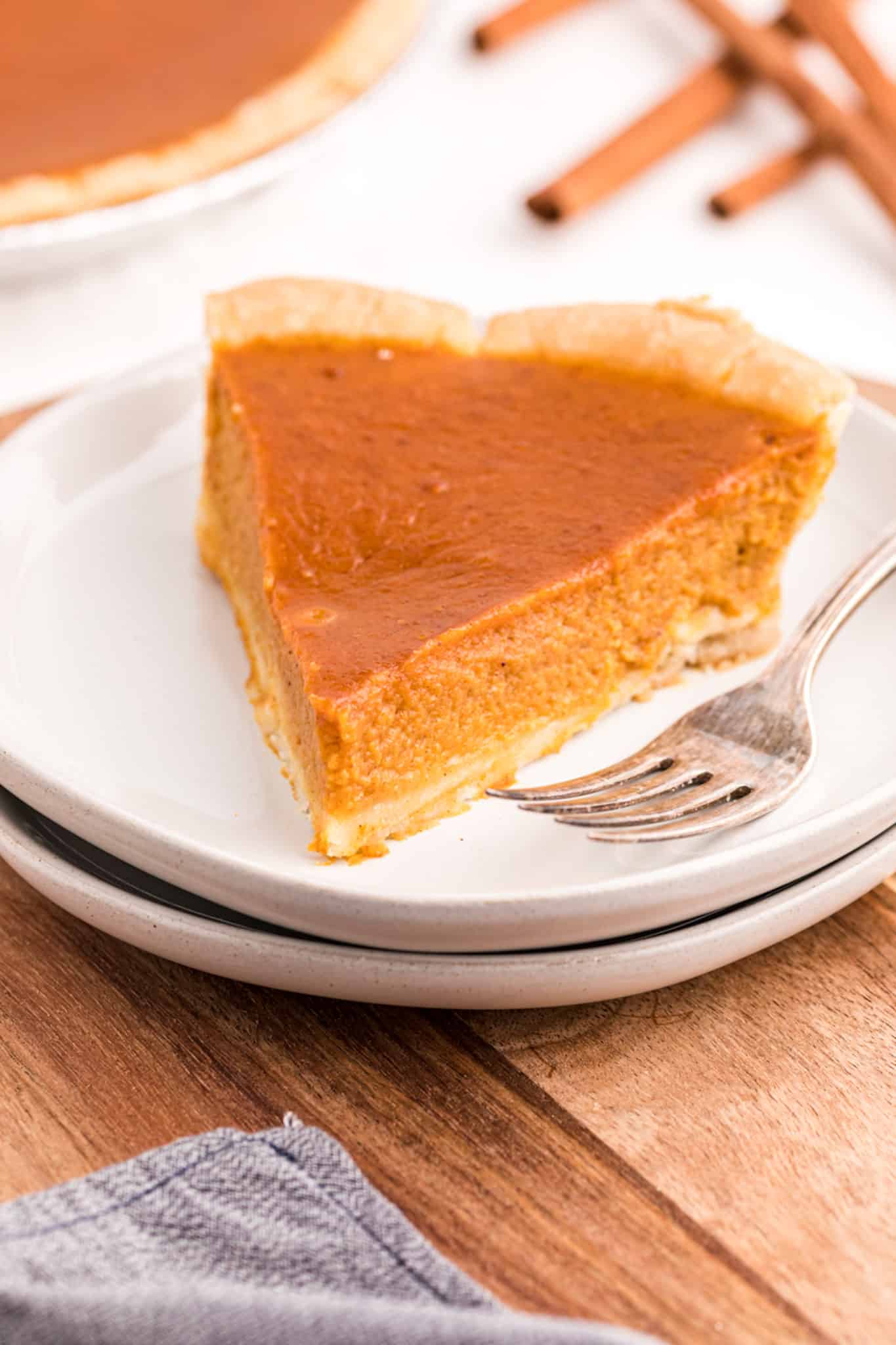 slice of gluten-free and dairy-free pumpkin pie on a white plate.