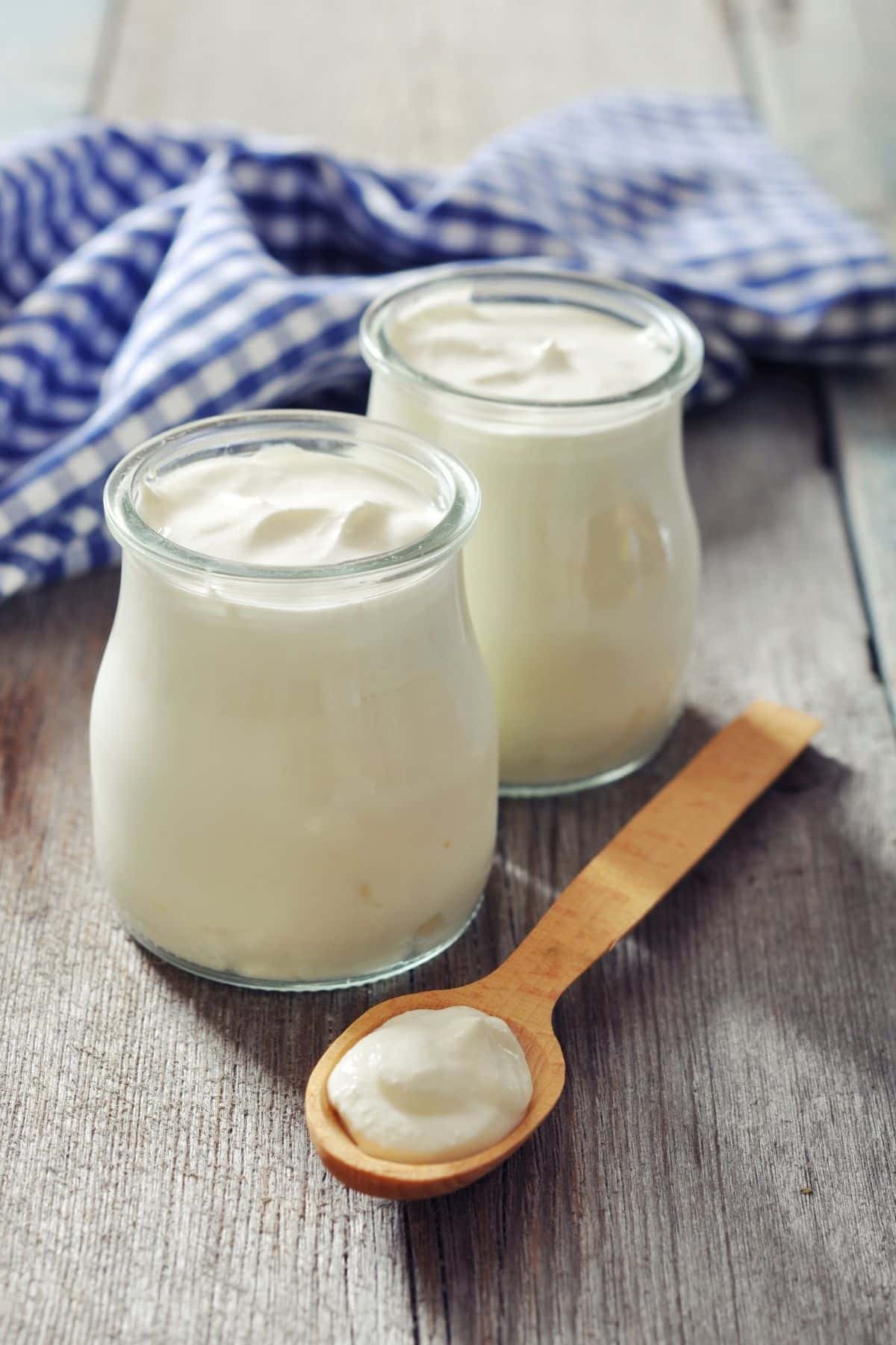 jars of yogurt on table.