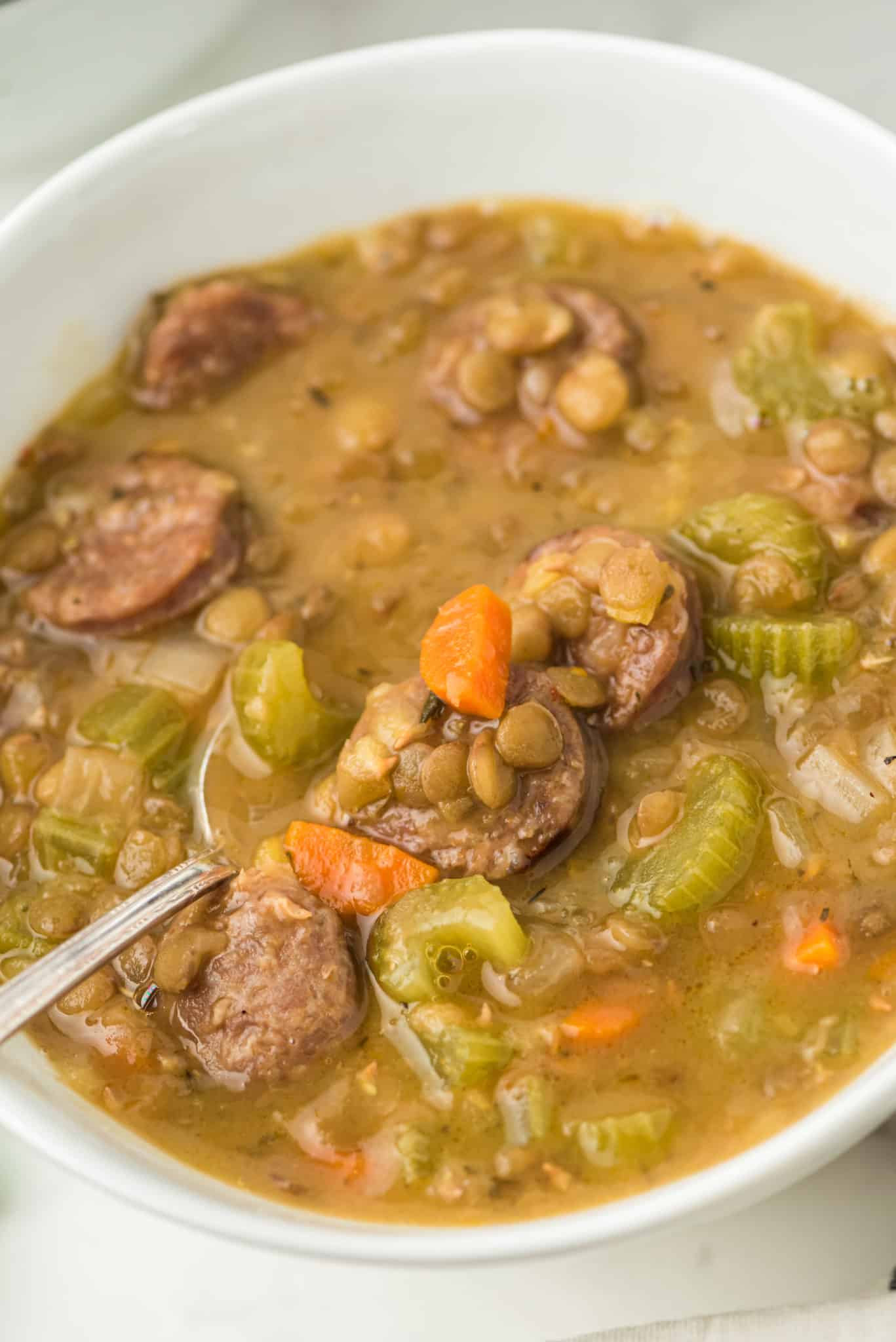 bowl of lentil soup with sausages.