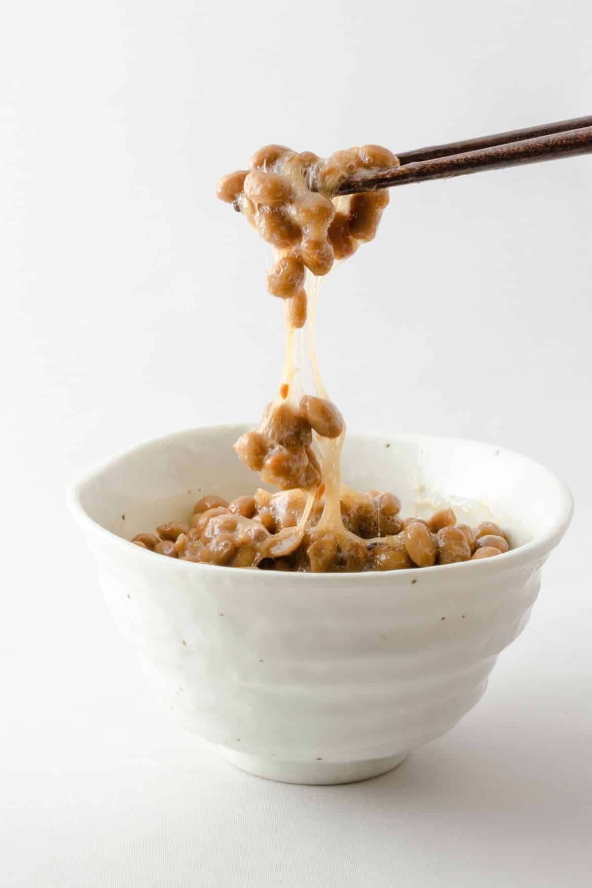 natto in bowl with chopsticks.