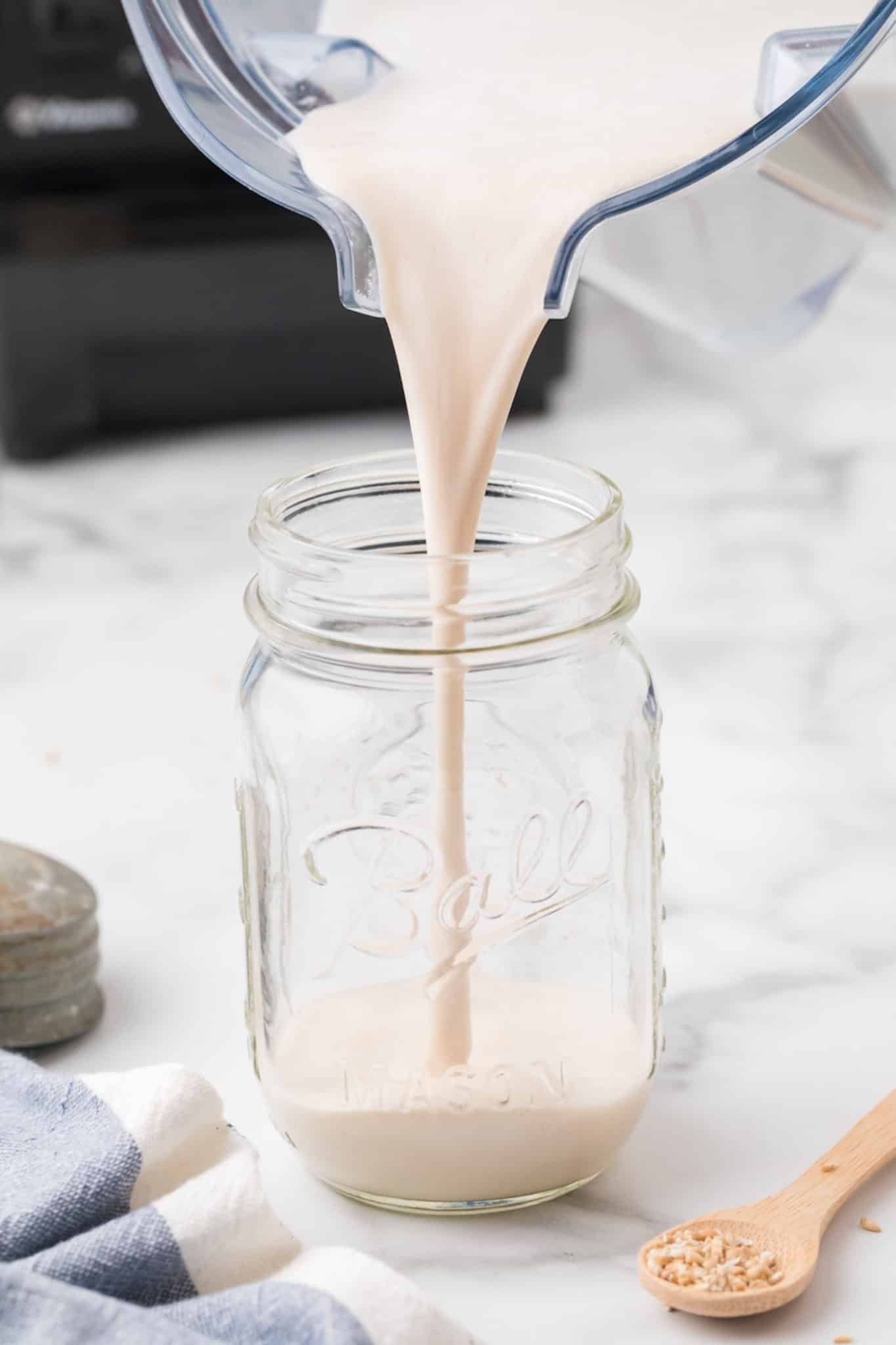 pouring oat milk recipe into jar