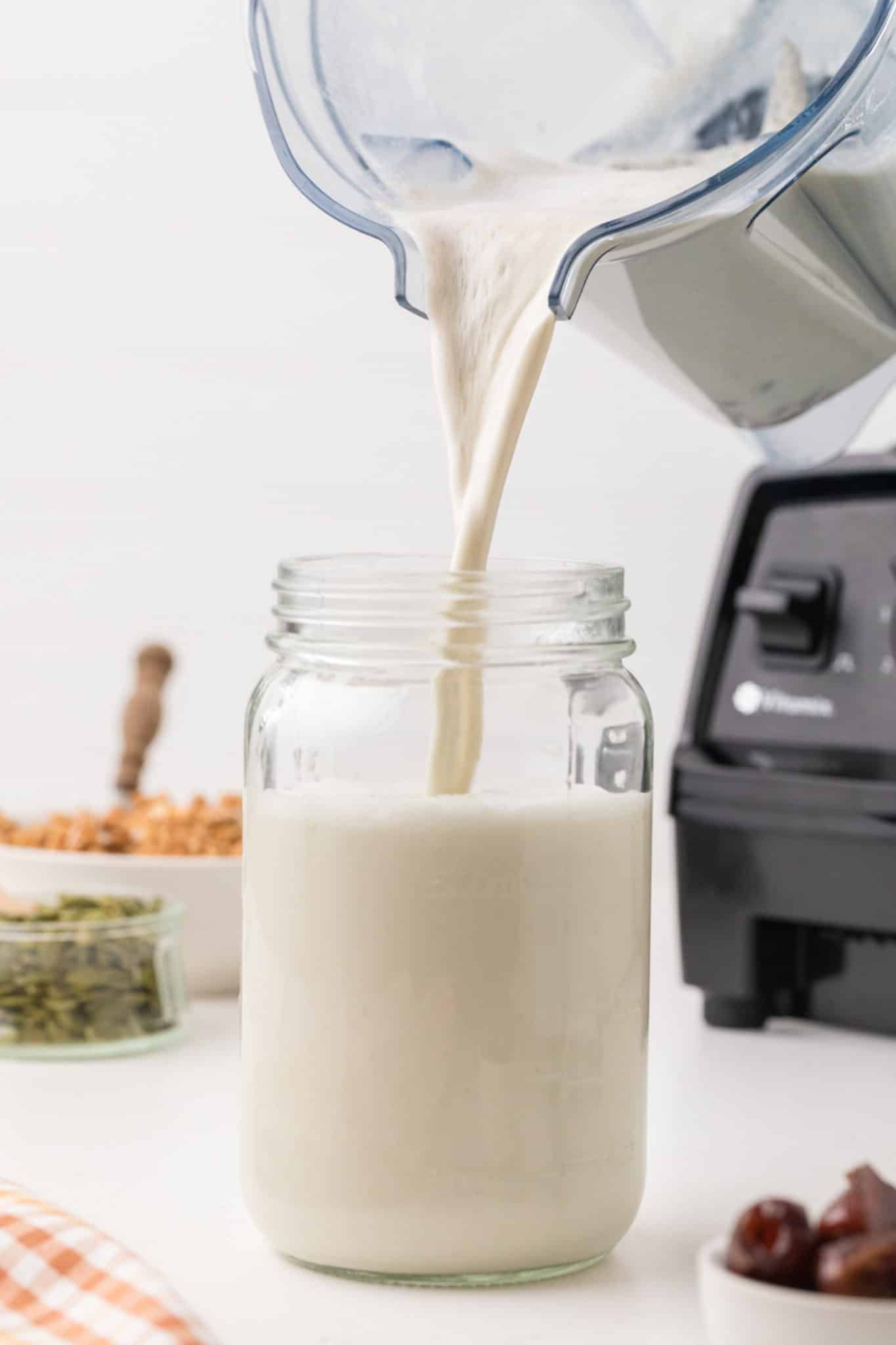 pouring pumpkin milk into jar.