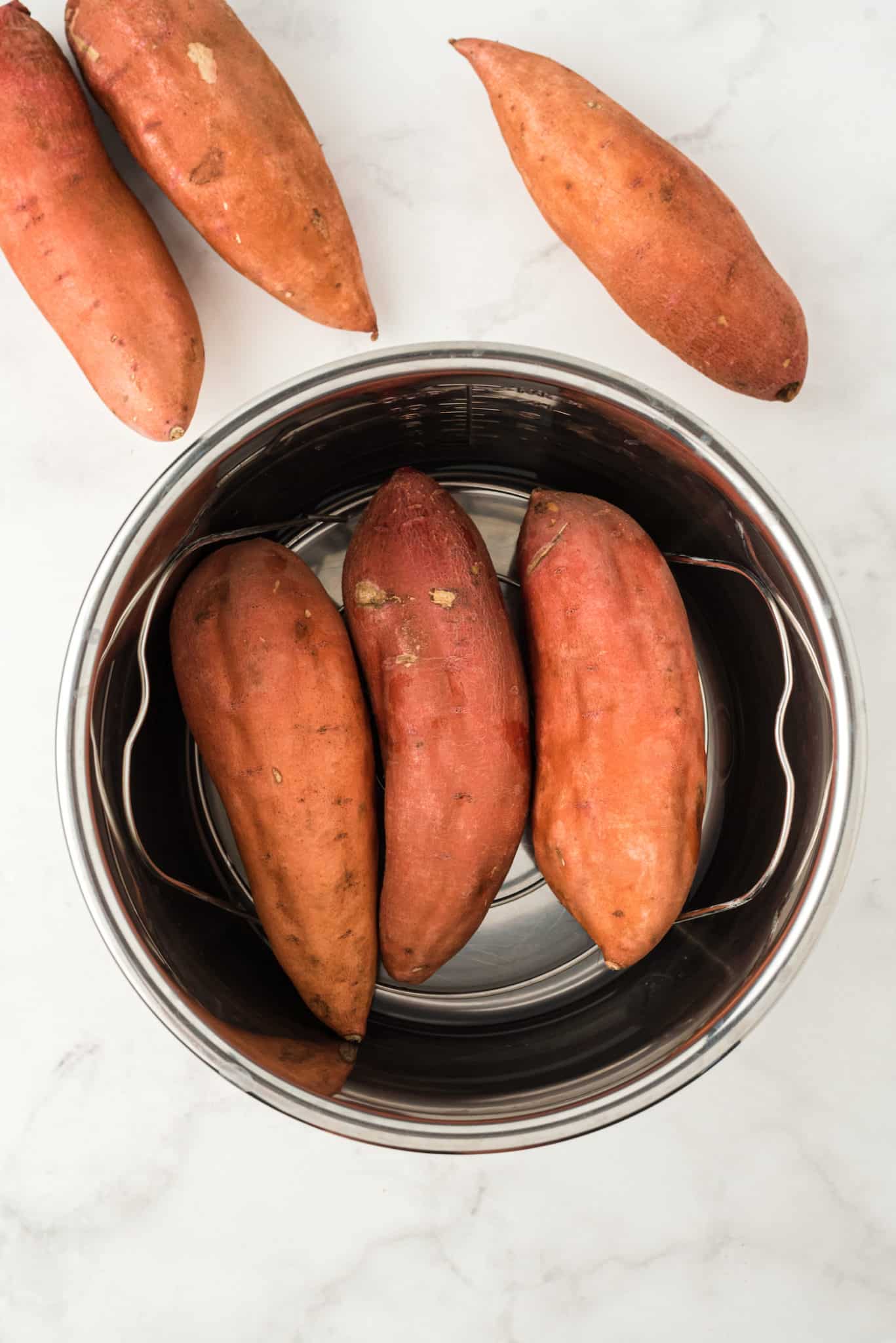 sweet potatoes on trivet inside instant pot