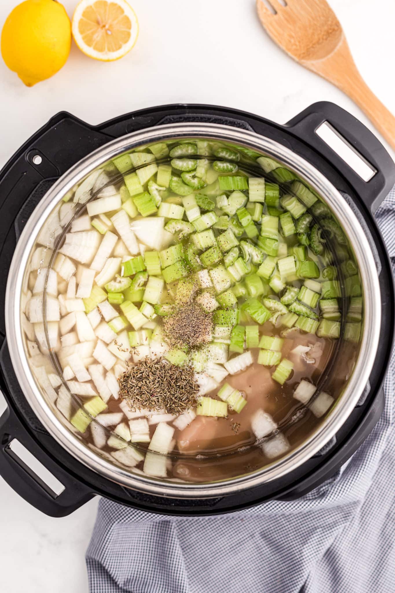 ingredients inside instant pot for making chicken rice soup.