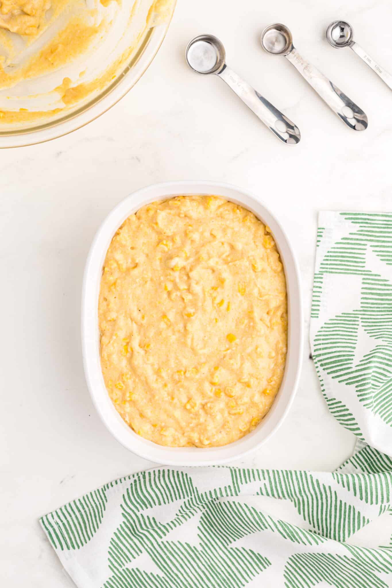 corn casserole ingredients in baking dish.