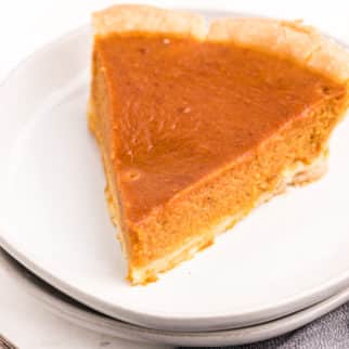 pumpkin pie slice on white plate