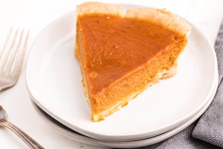 pumpkin pie slice on white plate
