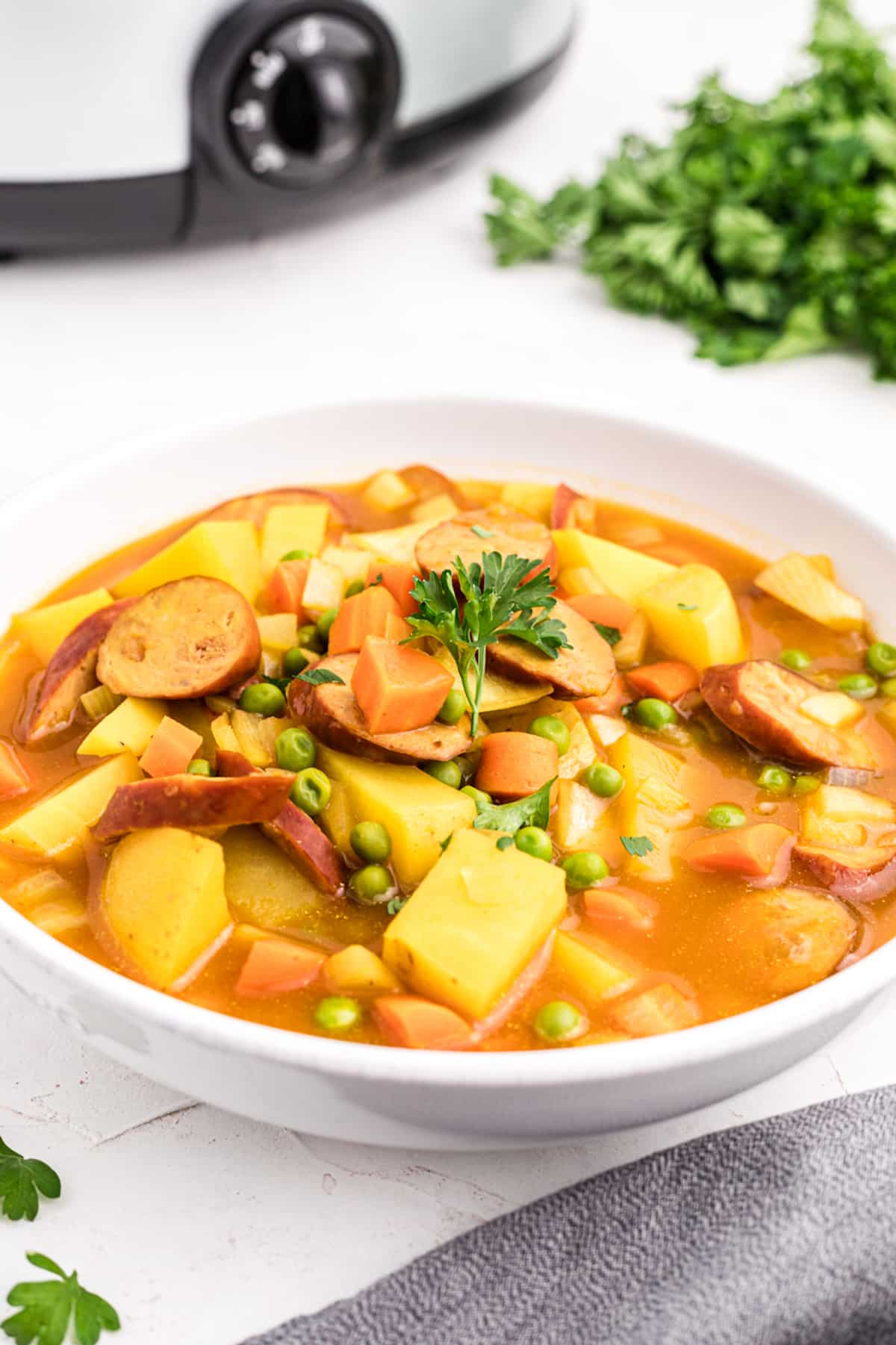 a bowl of sausage and potato curry