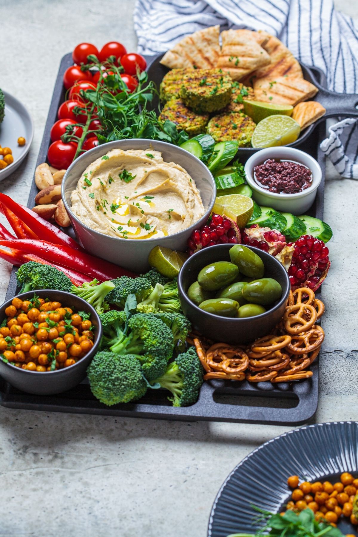 vegan charcuterie board with vegetables and hummus.