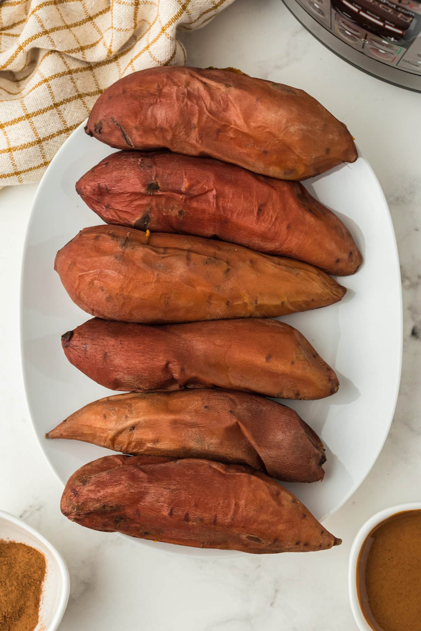 baked whole sweet potatoes on serving platter.