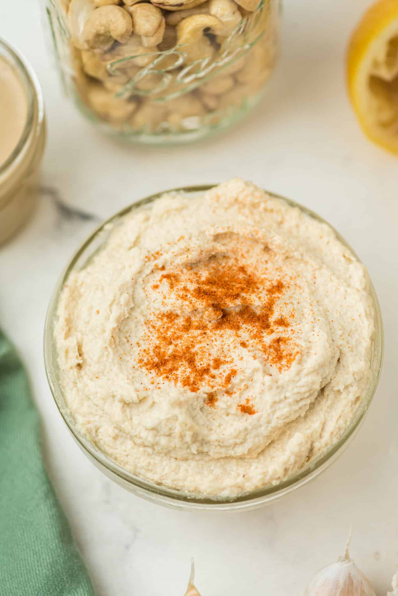 cashew hummus in a bowl sprinkled with paprika.