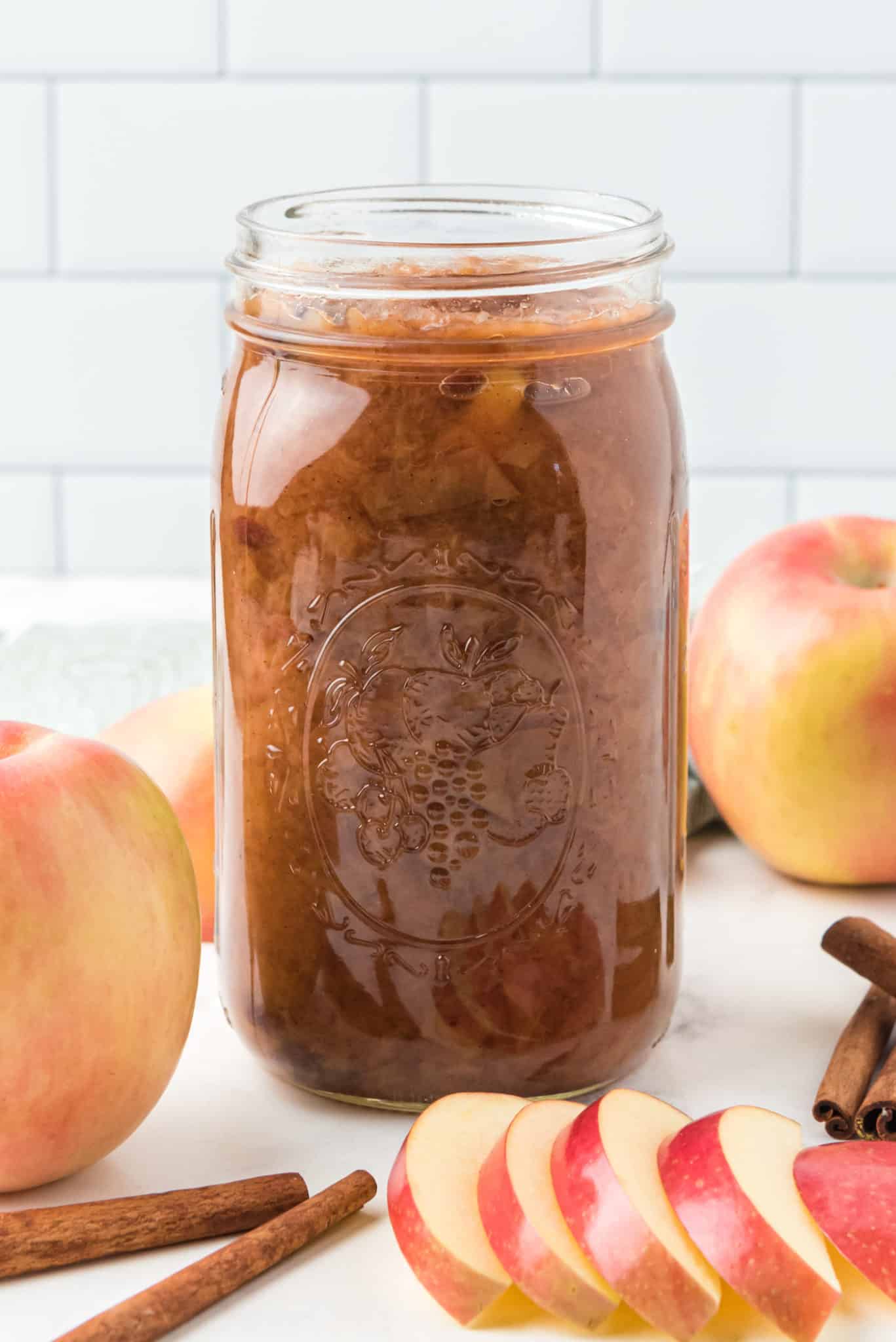 jar of crockpot applesauce in a jar on a table.