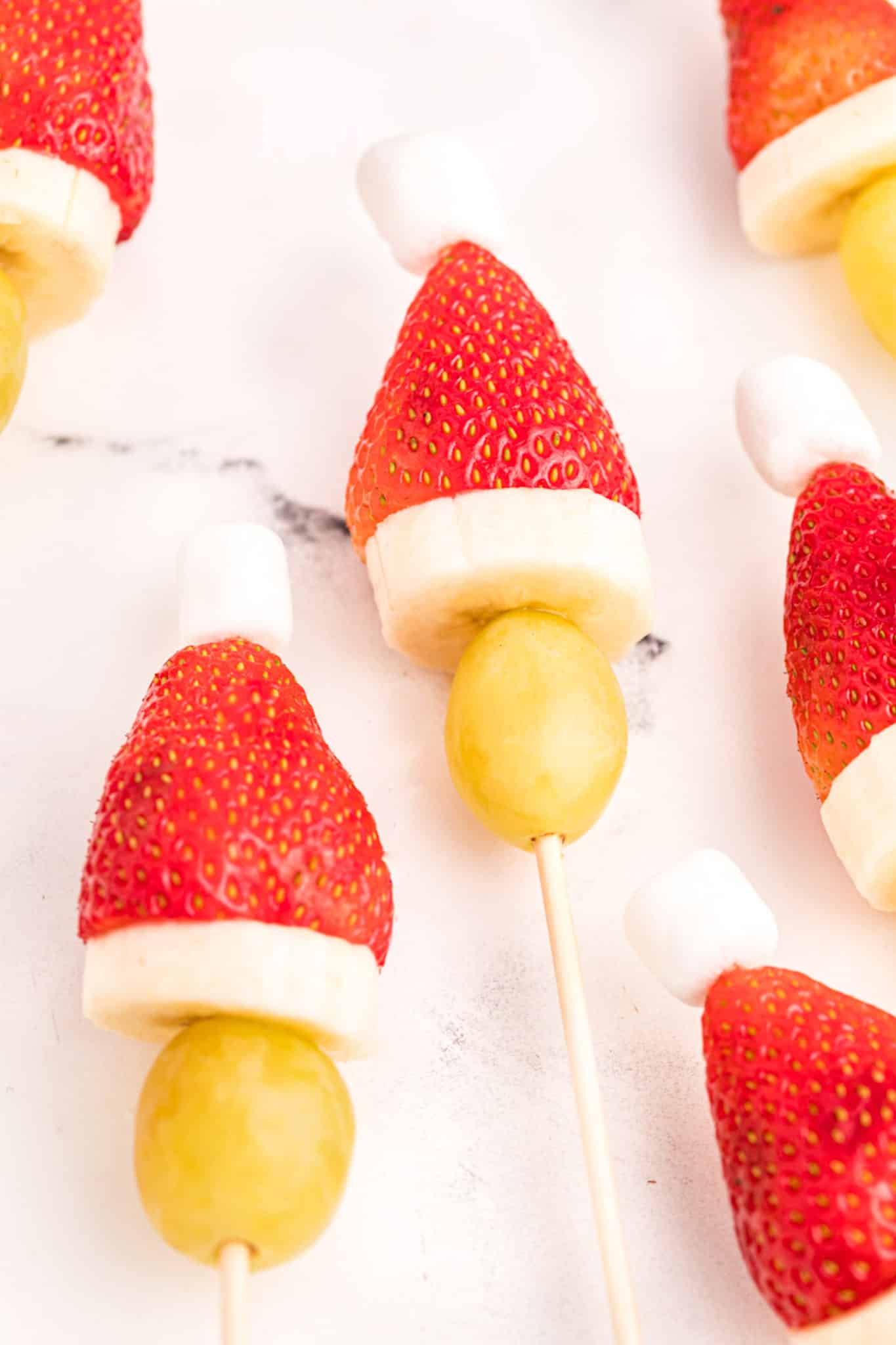 photo of grinch fruit kebob with strawberry, grape and marshmallow.