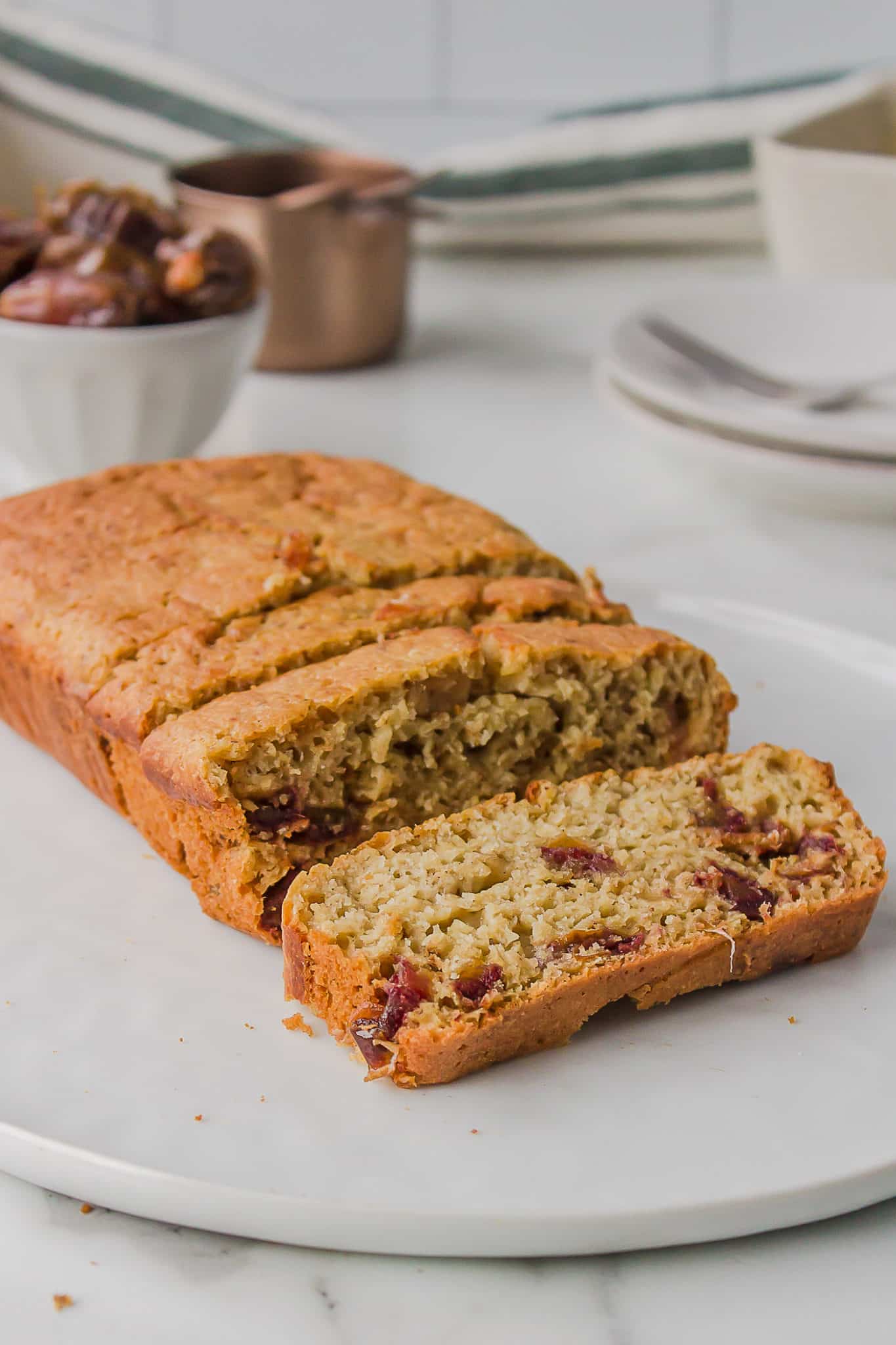 sliced gluten-free date nut bread on a plate.