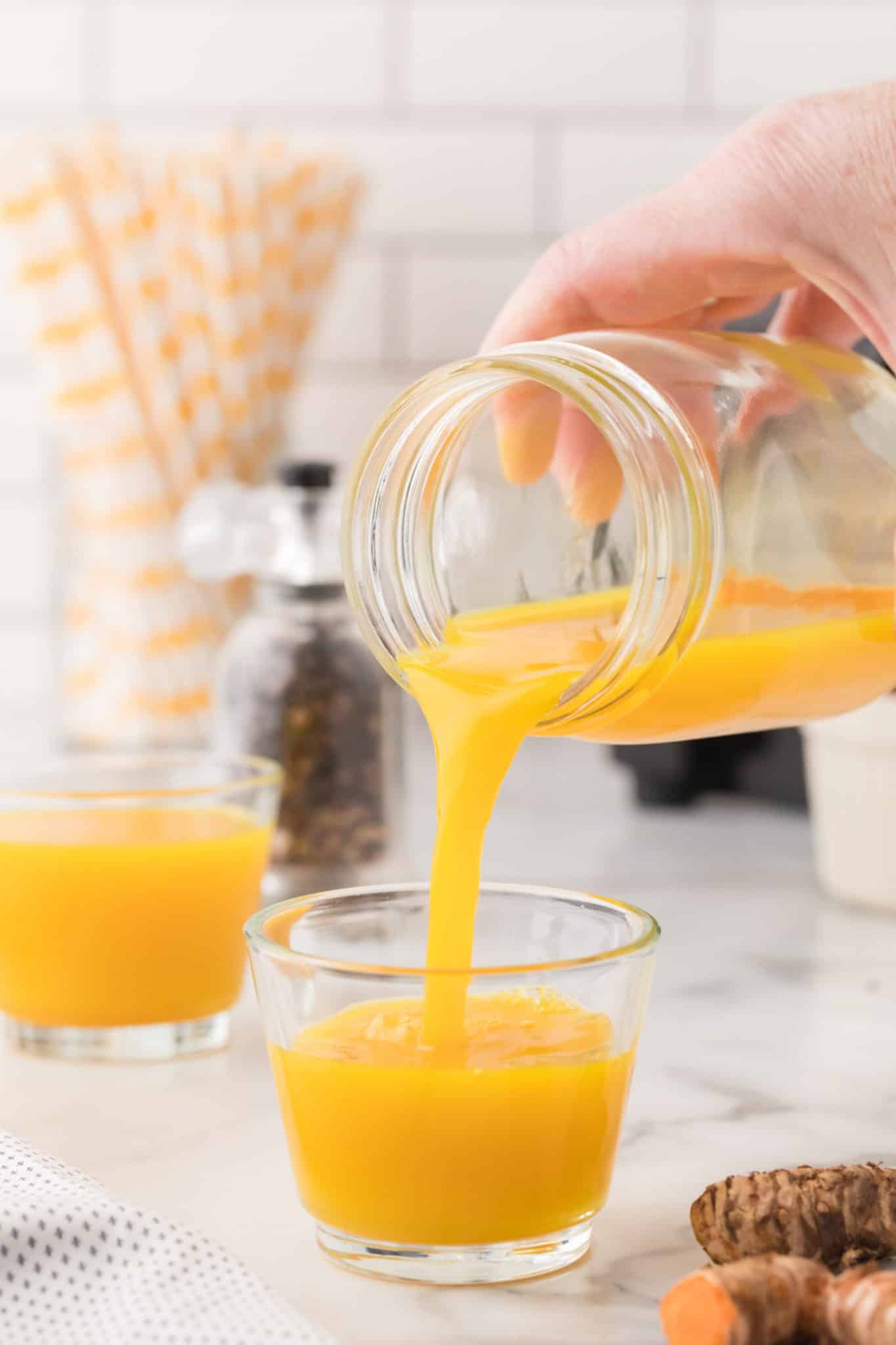 pouring a turmeric shot.