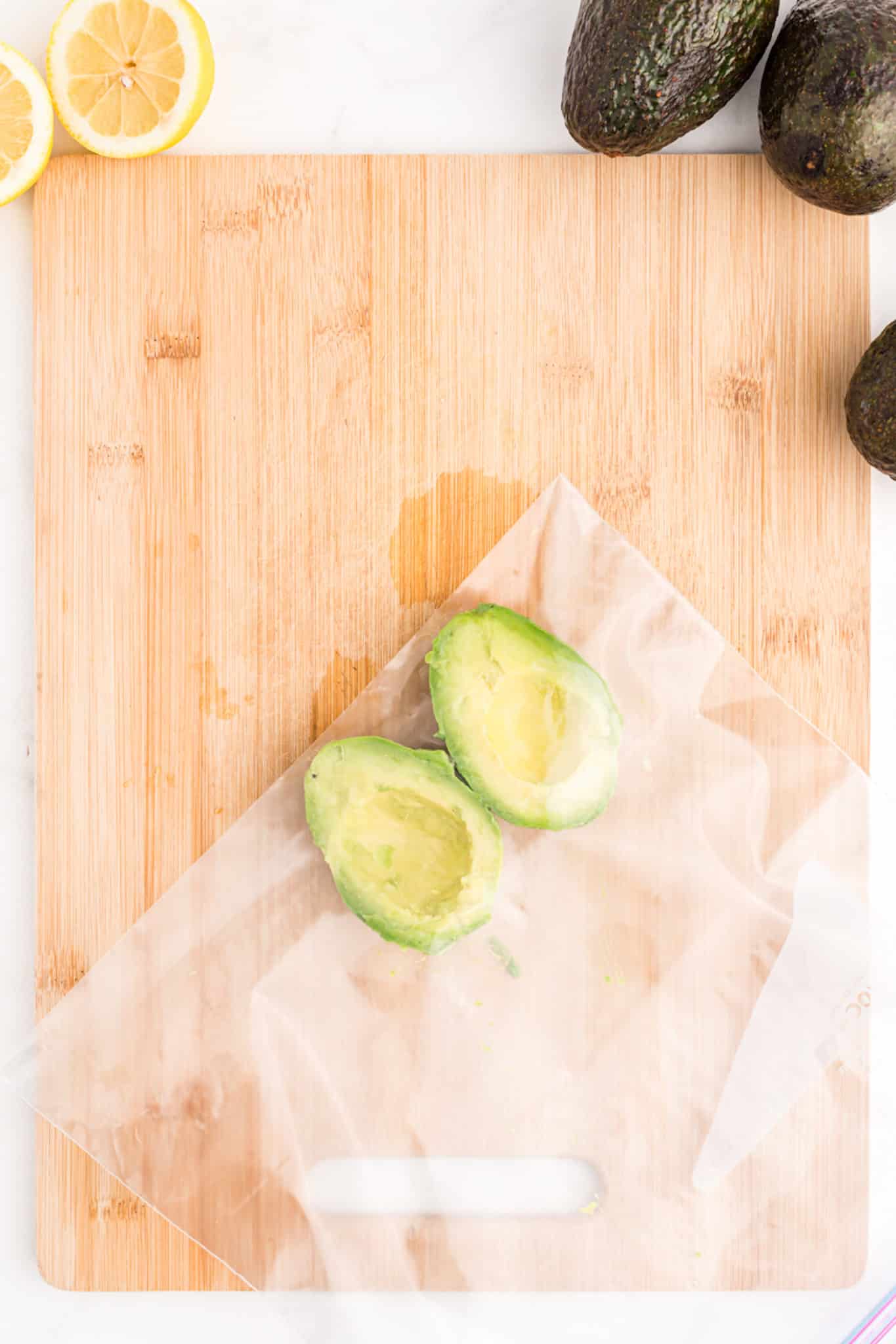 avocado halves in a plastic bag ready for the freezer.