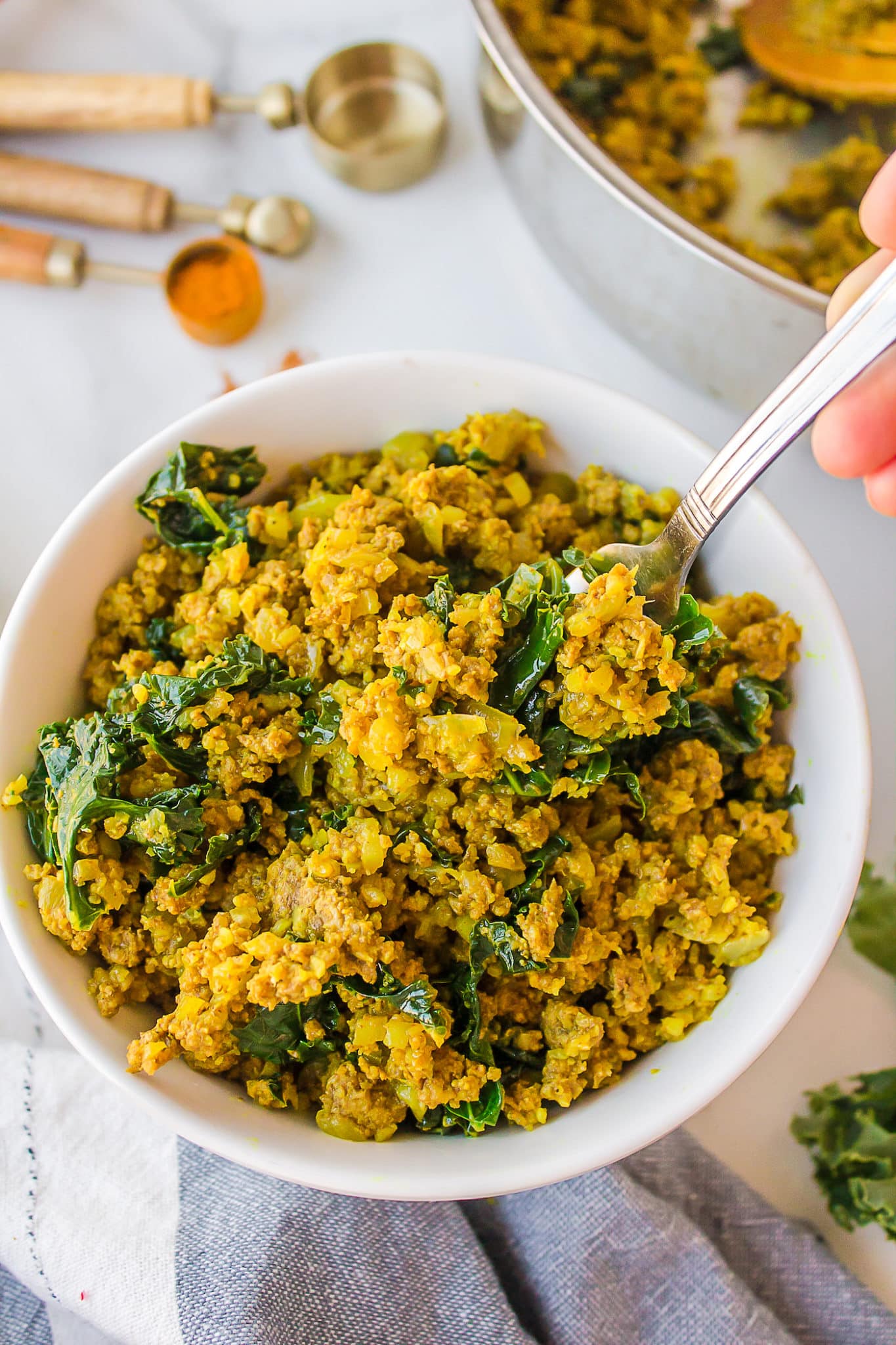 bowl filled with cooked rice, kale, and bison.