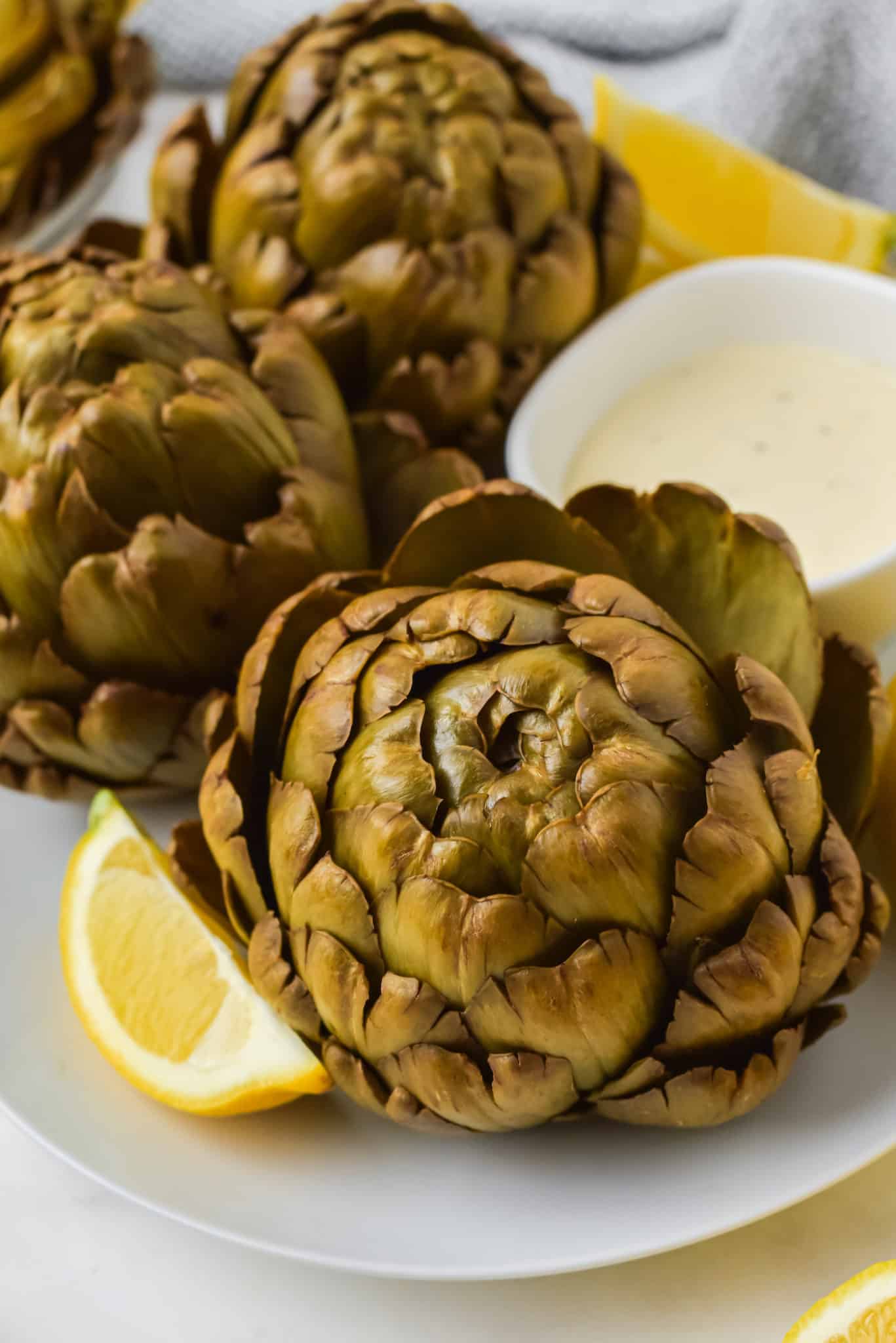 close up of artichokes on a platter.