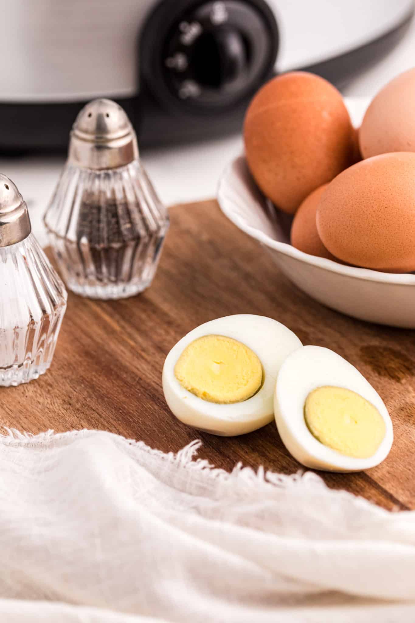 cooked crockpot hard boiled eggs ready to eat on a plate.