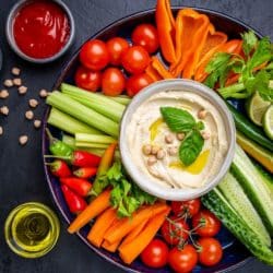 A plate of veggies and hummus.