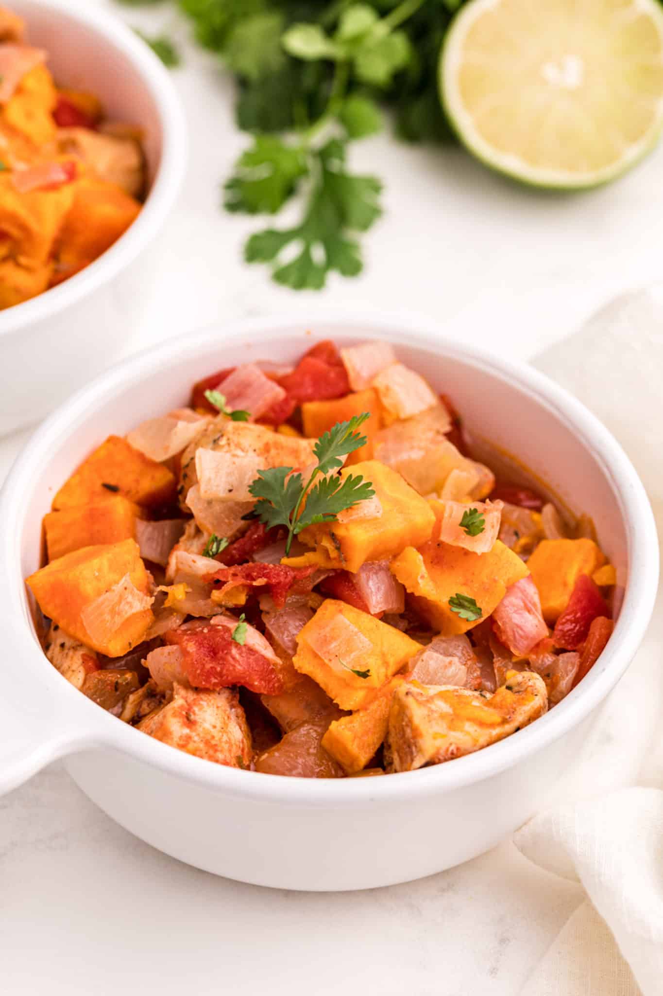 chicken and sweet potato recipe in a white bowl