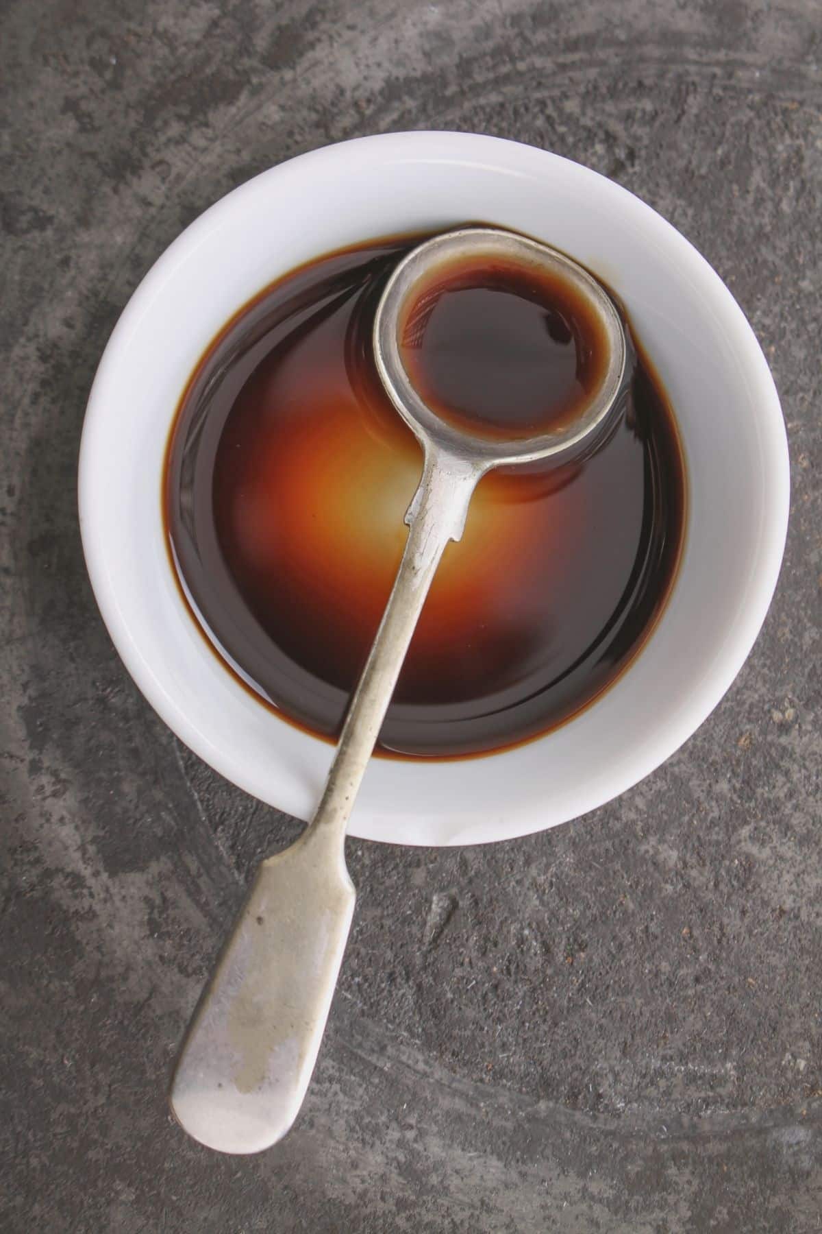 liquid aminos in bowl with spoon.