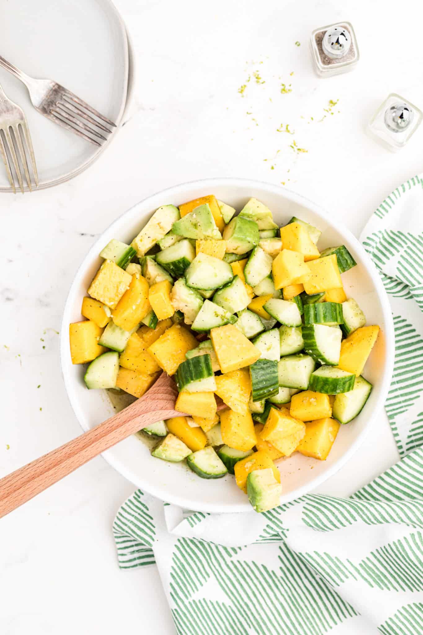 a bowl of mango avocado cucumber salad.