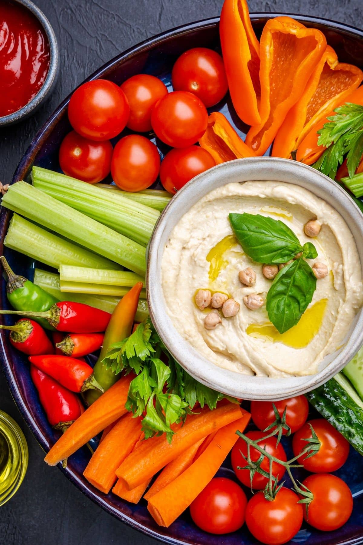 bowl of hummus with vegetables.