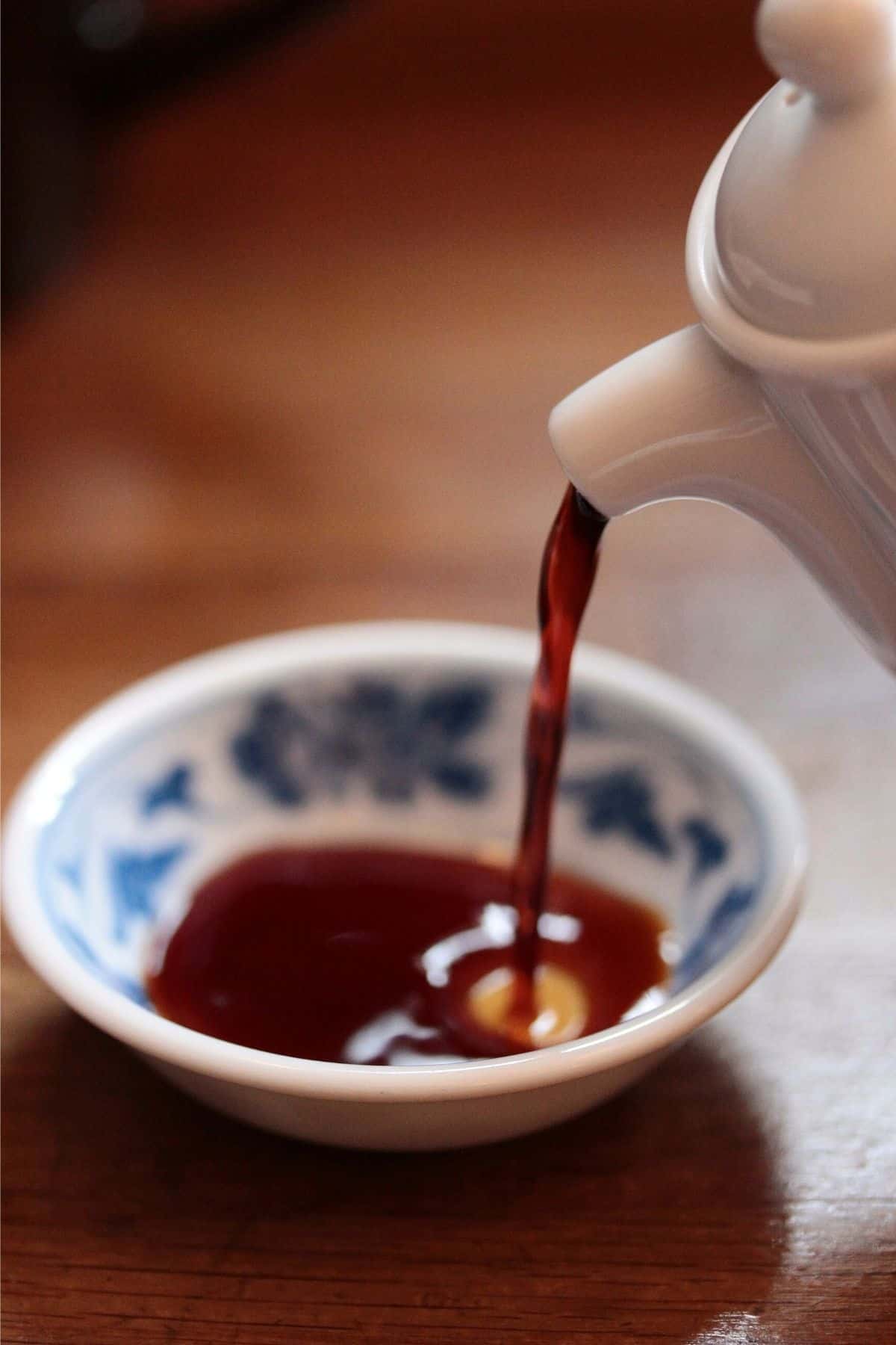 pouring coconut aminos into a bowl.