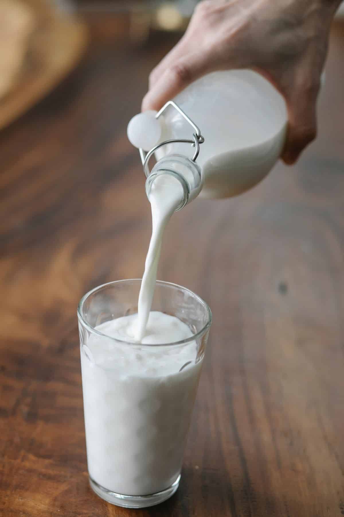 pouring milk into a glass.