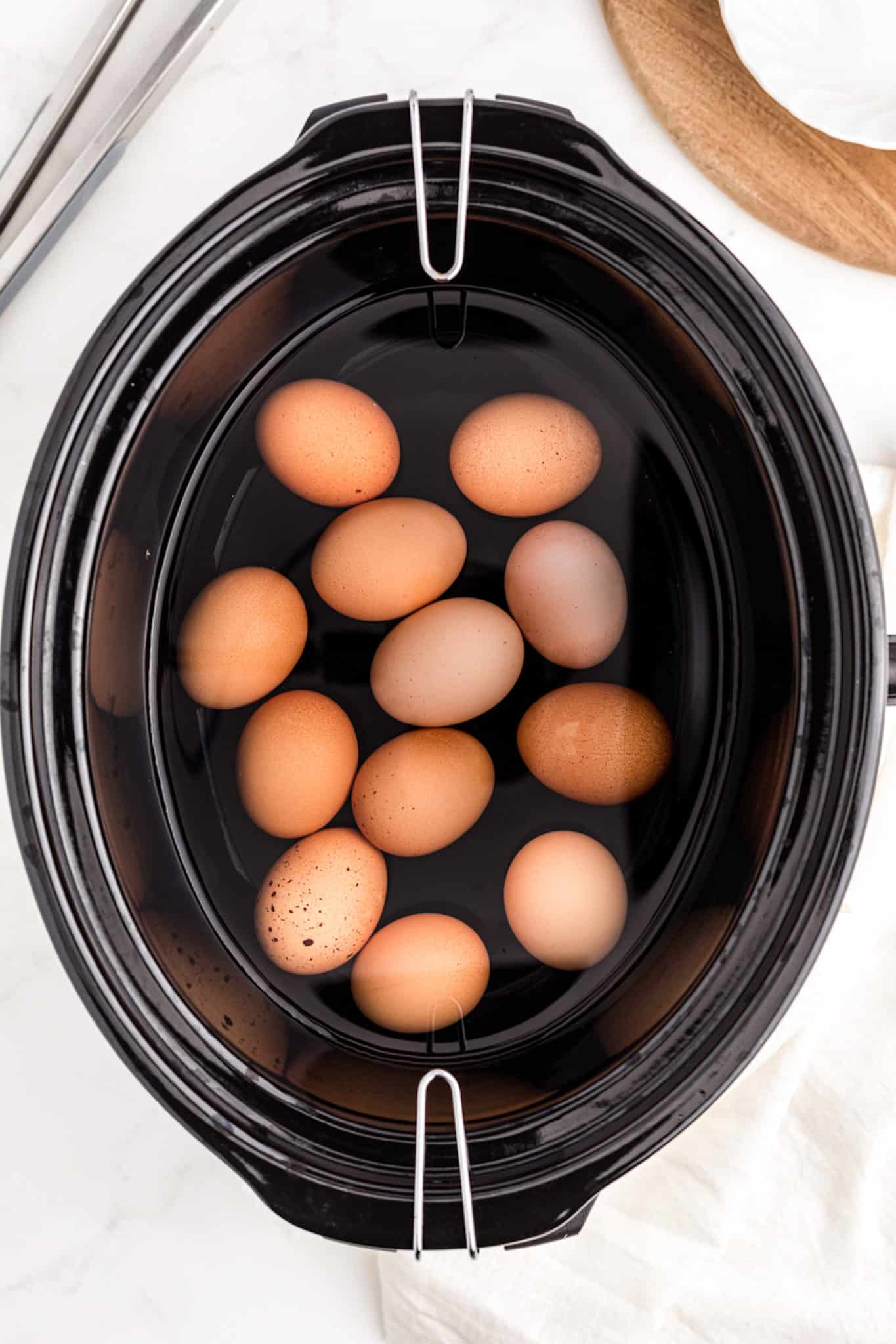 a crockpot with eggs and water