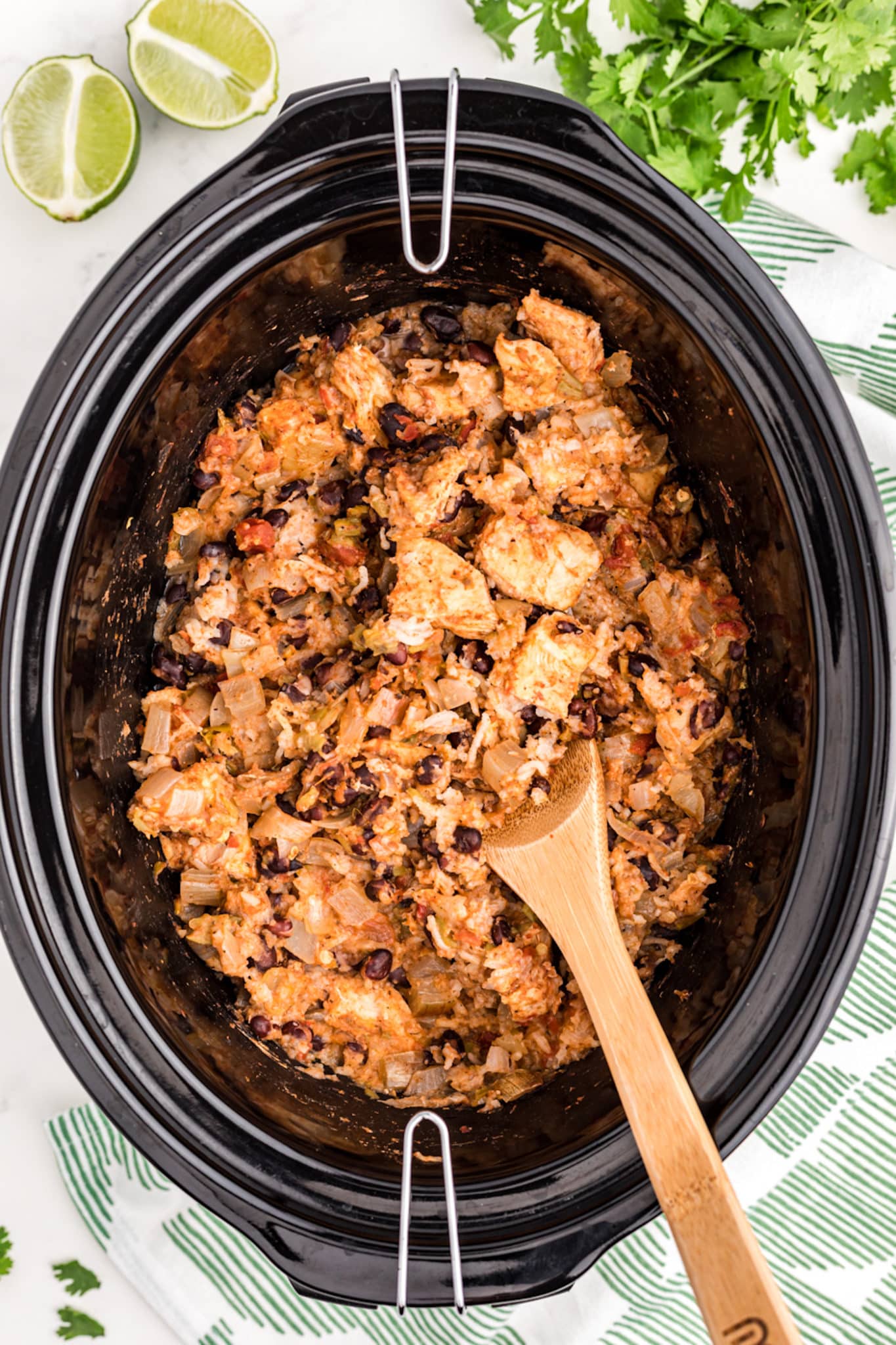 a crockpot with cooked chicken and rice.
