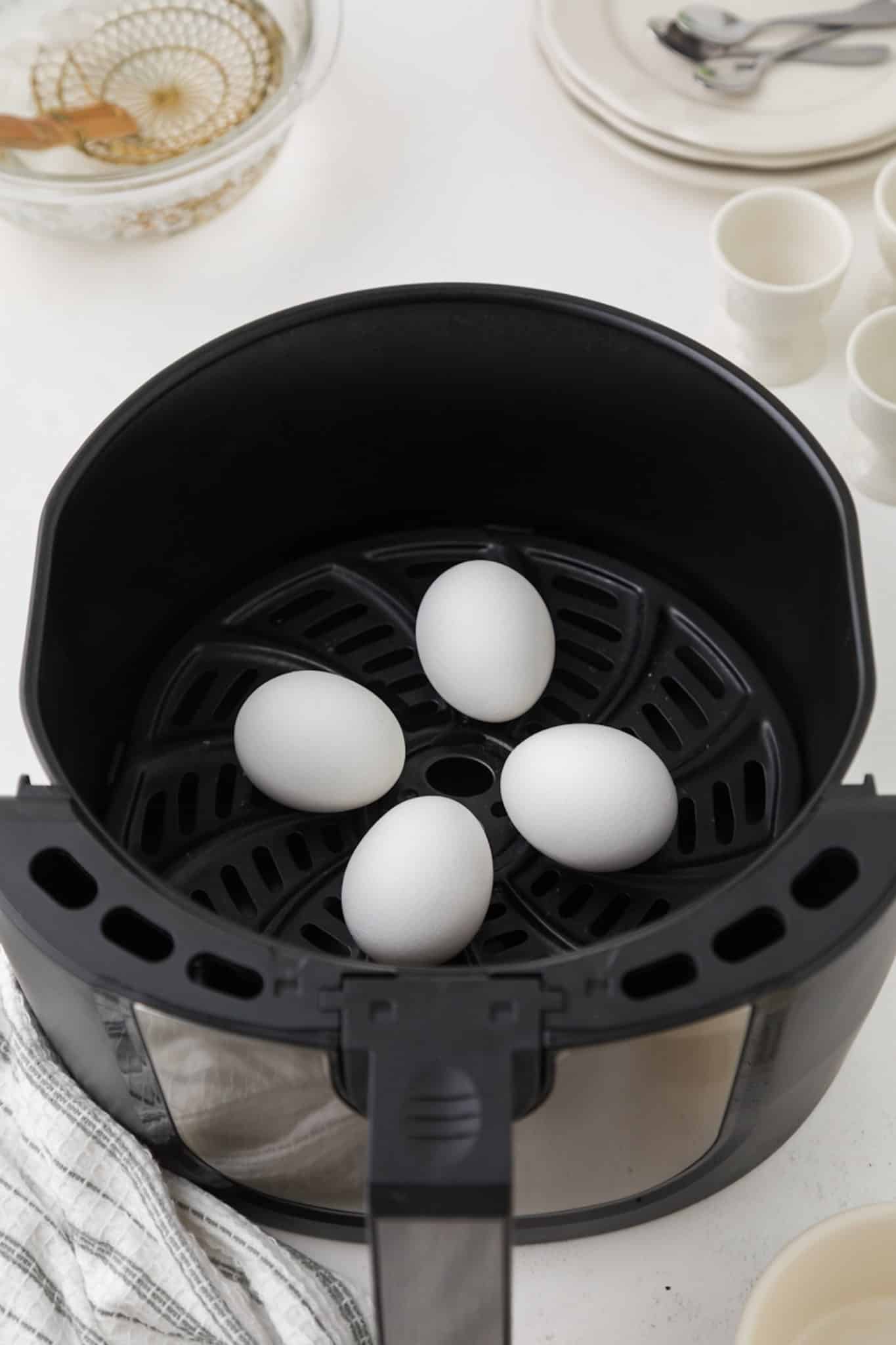 cooked eggs inside air fryer basket