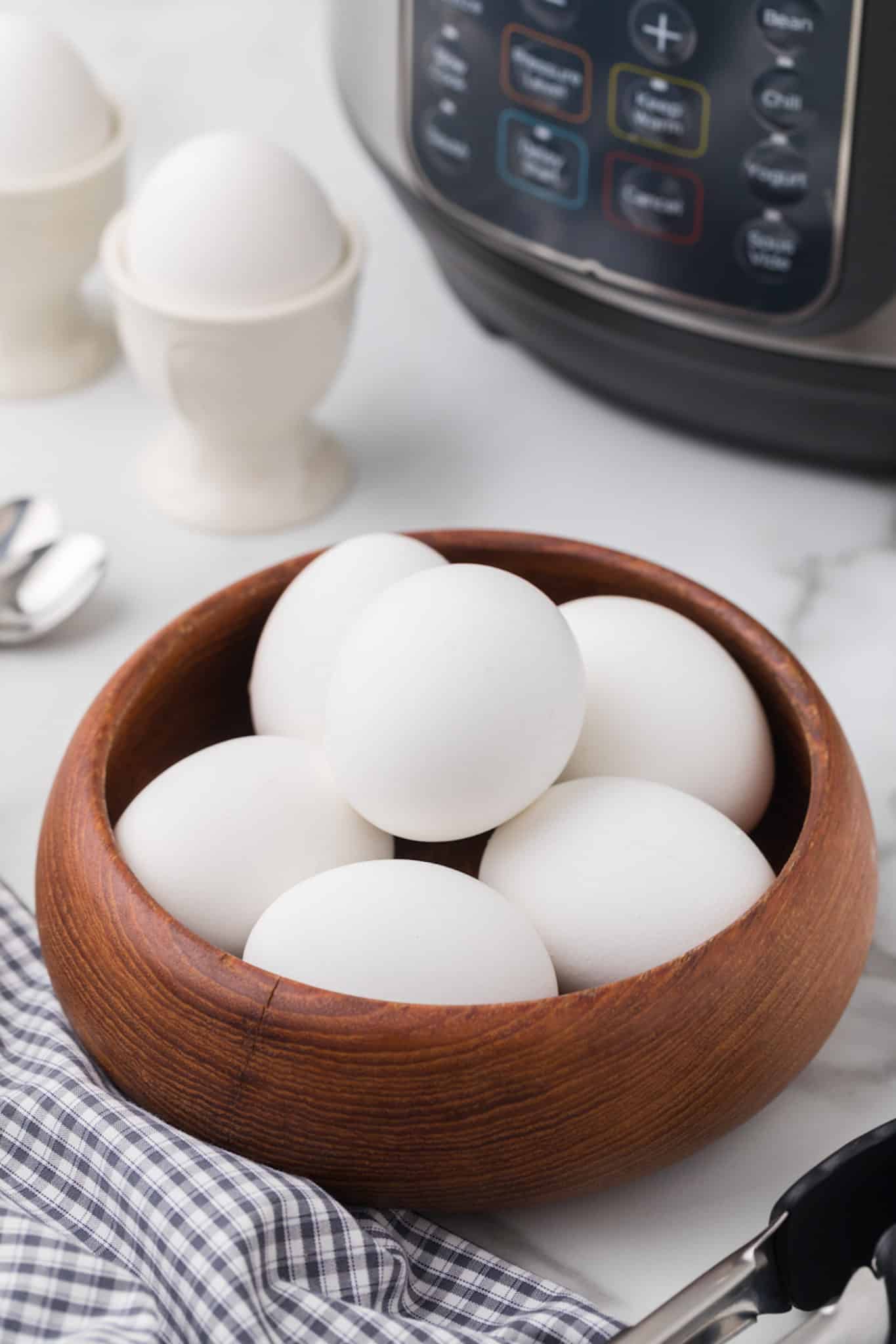 eggs in a bowl on a table ready to be cooked in instant pot.