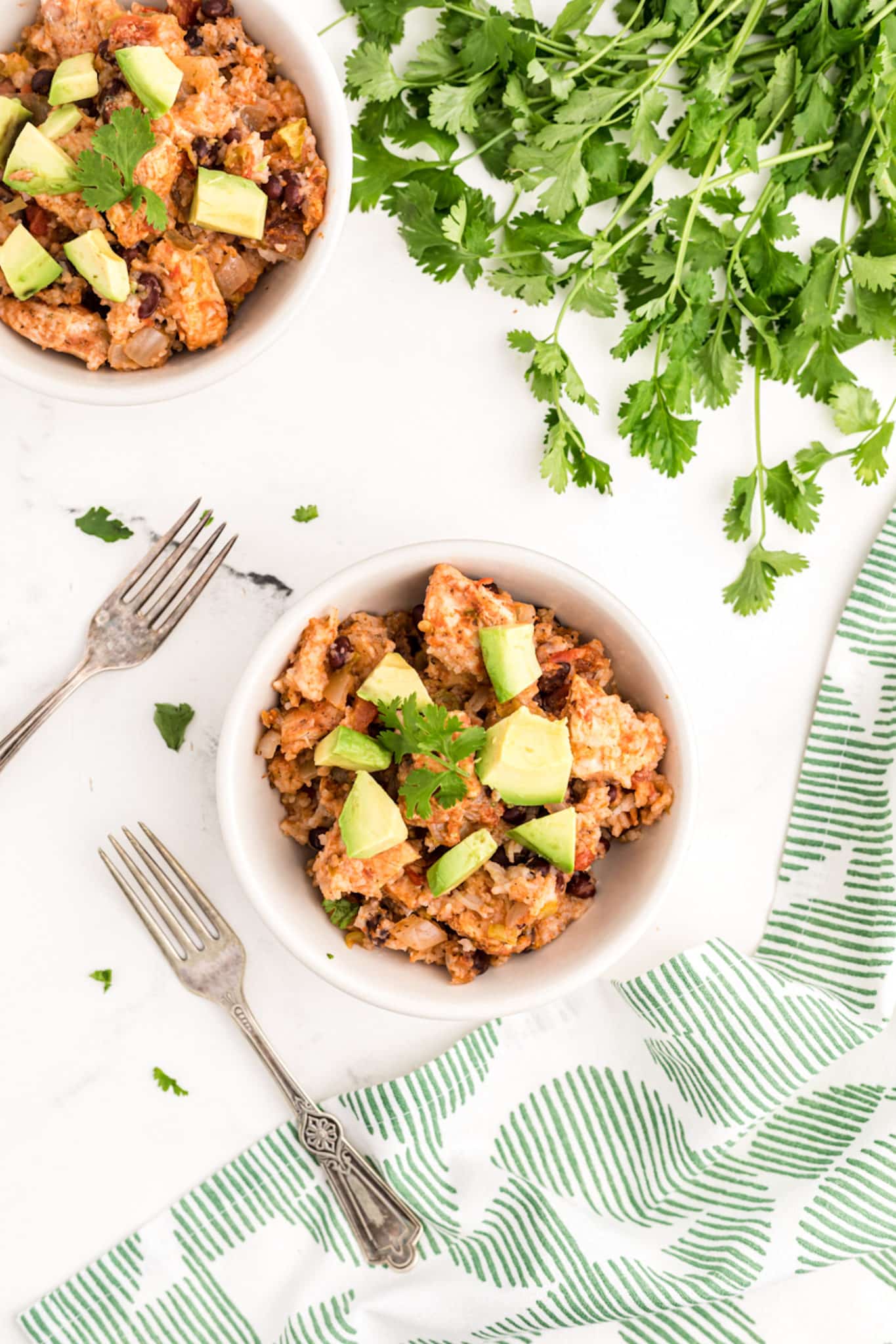 a bowl of slow cooker chicken and rice with avocado.